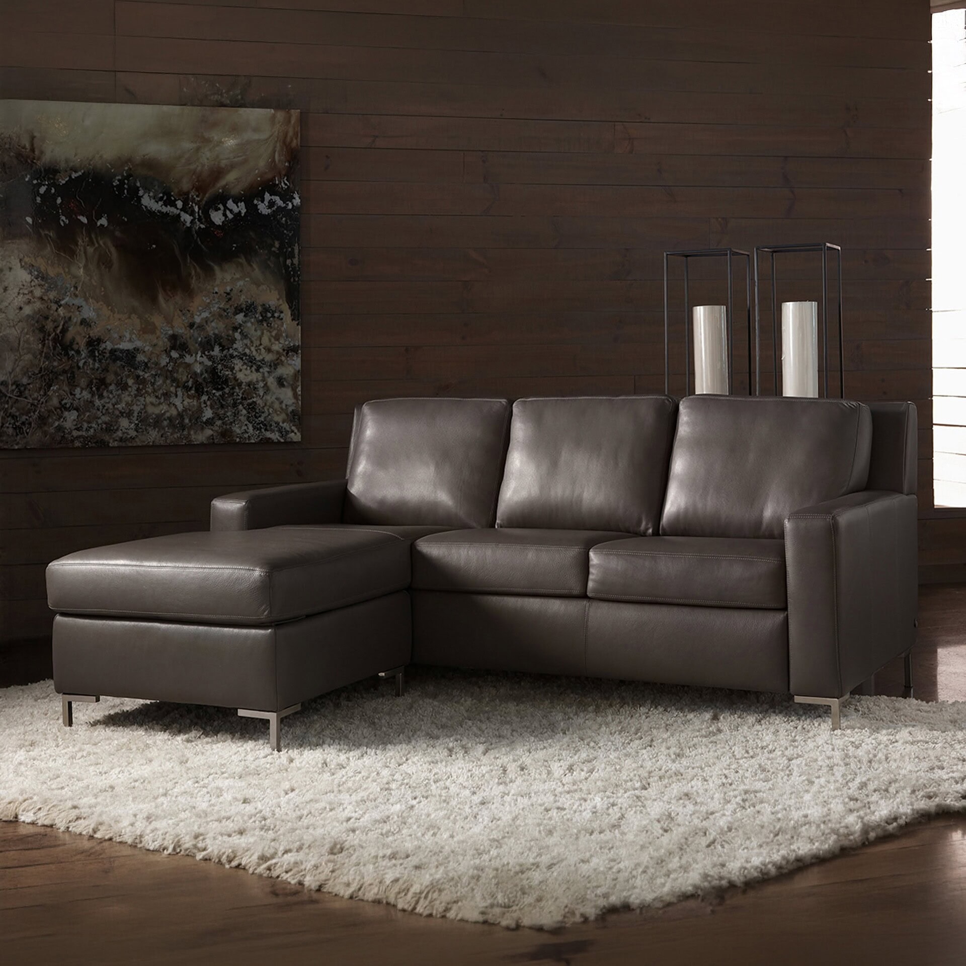 Stylish dark brown leather sectional with clean lines and metal legs for contemporary living spaces.