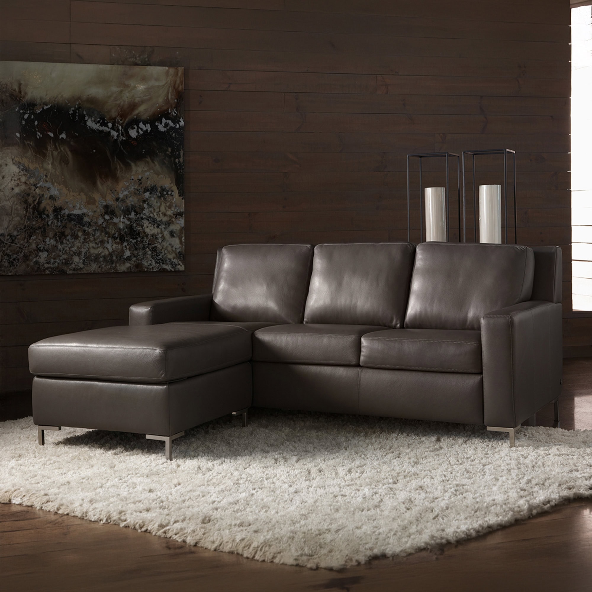 Stylish dark brown leather sectional with clean lines and metal legs for contemporary living spaces.