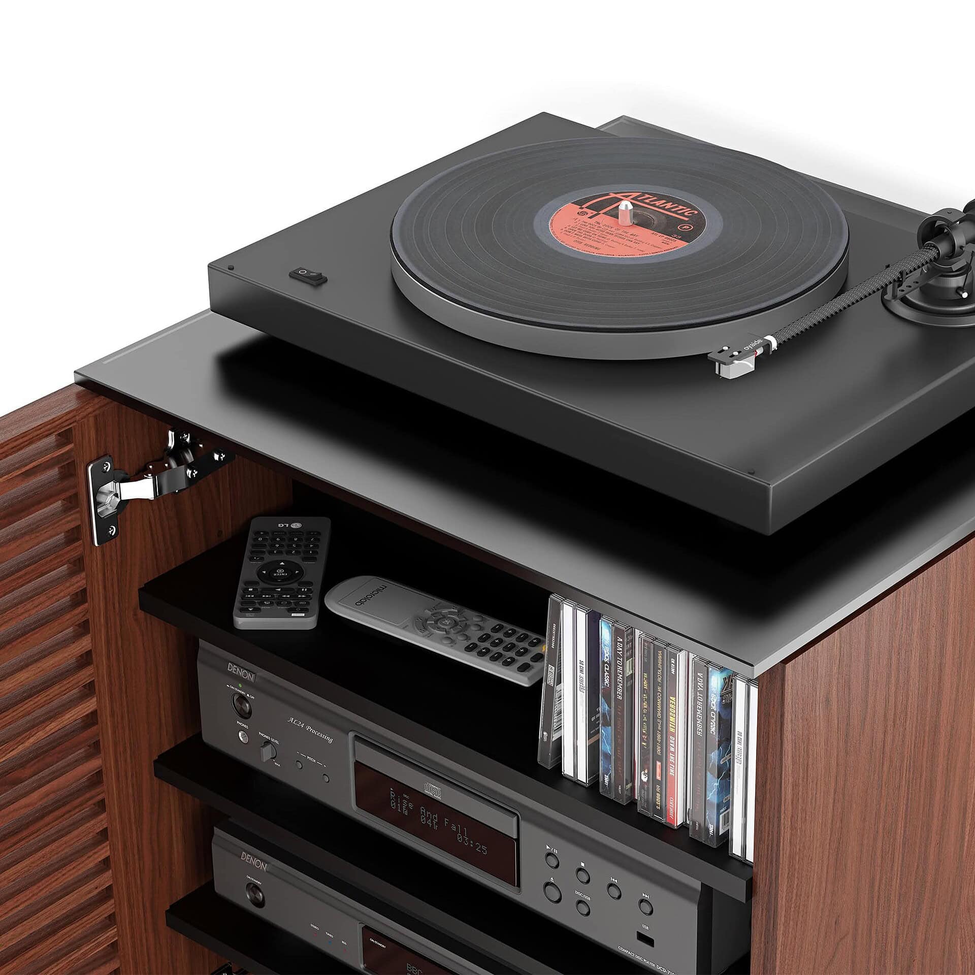 Turntable and audio system on wooden furniture with CDs and remote controls.
