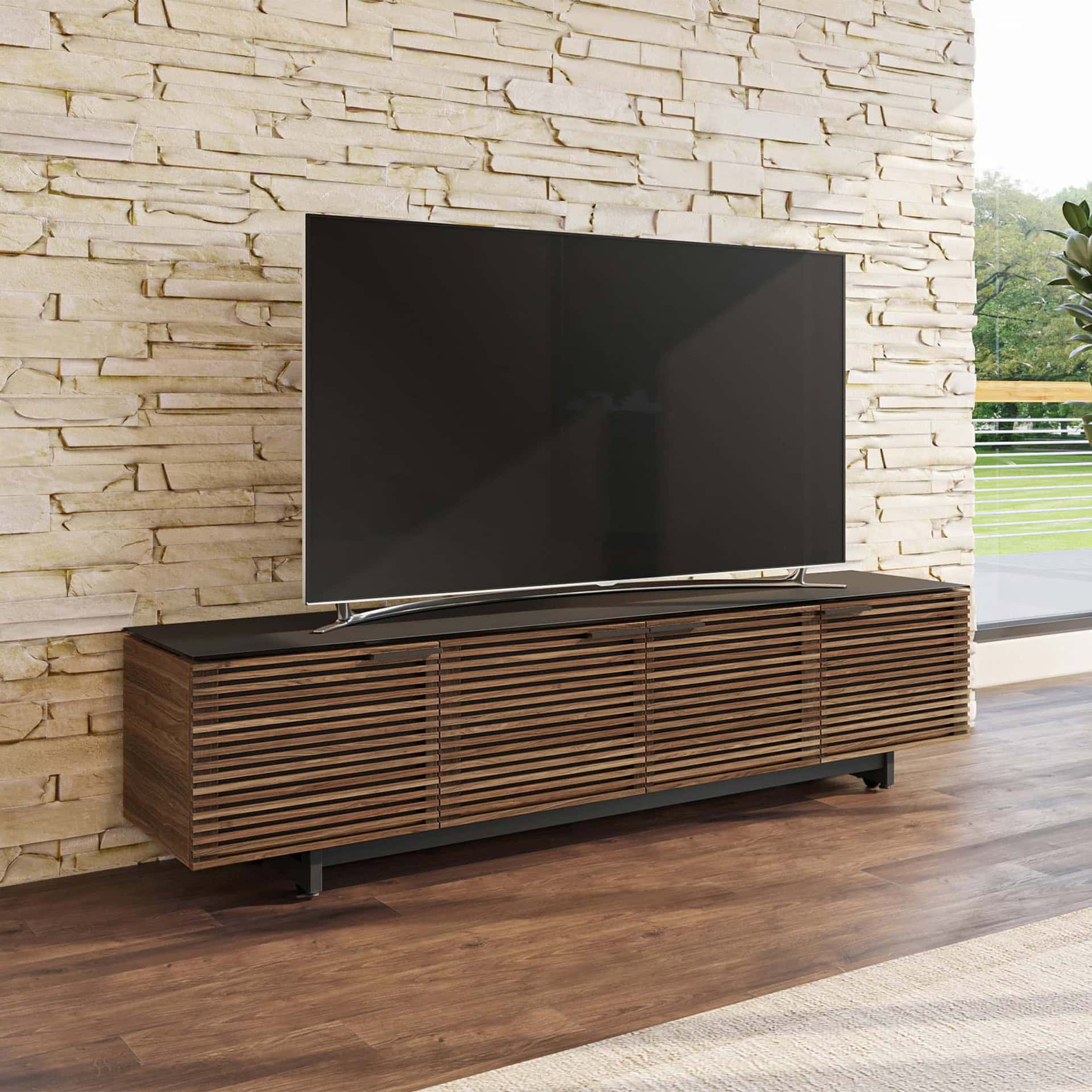 Sleek modern wooden media console with slatted cabinet doors for stylish TV storage.