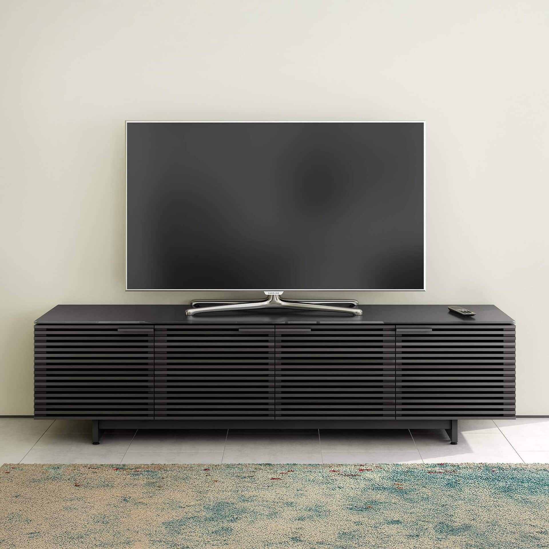 Contemporary black media console with slatted design for modern living room decor.