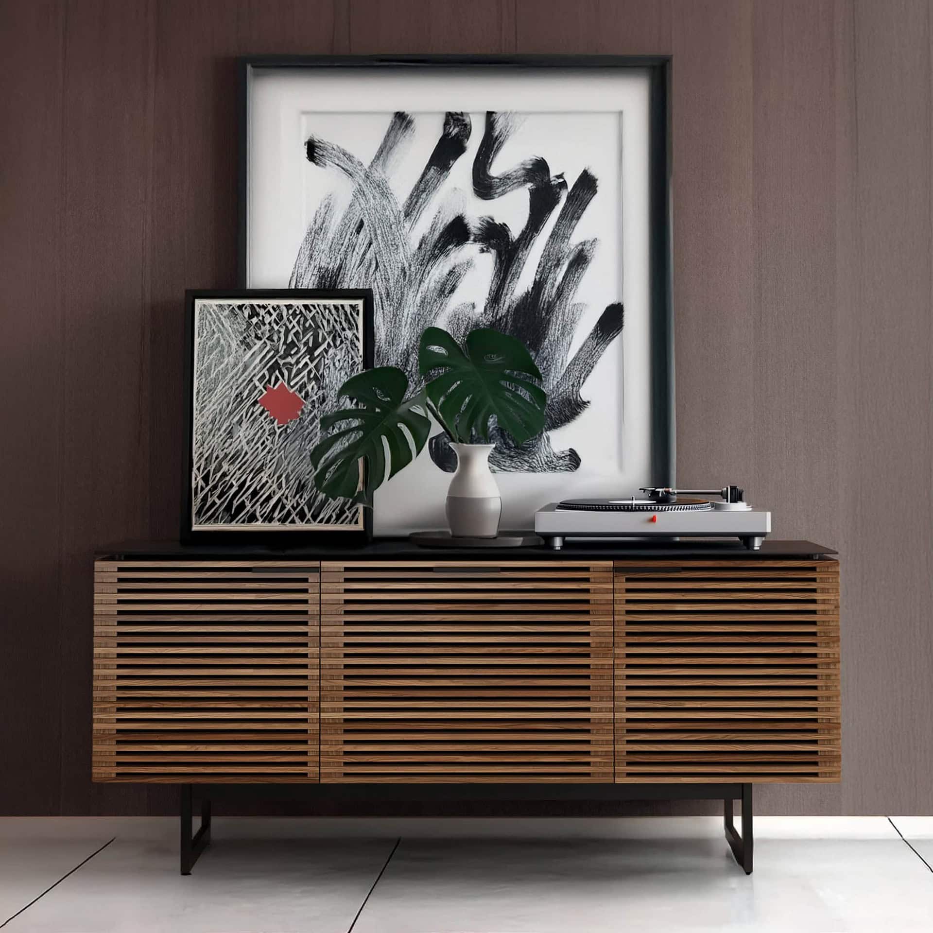 Contemporary wooden sideboard with artwork and turntable, modern interior design.