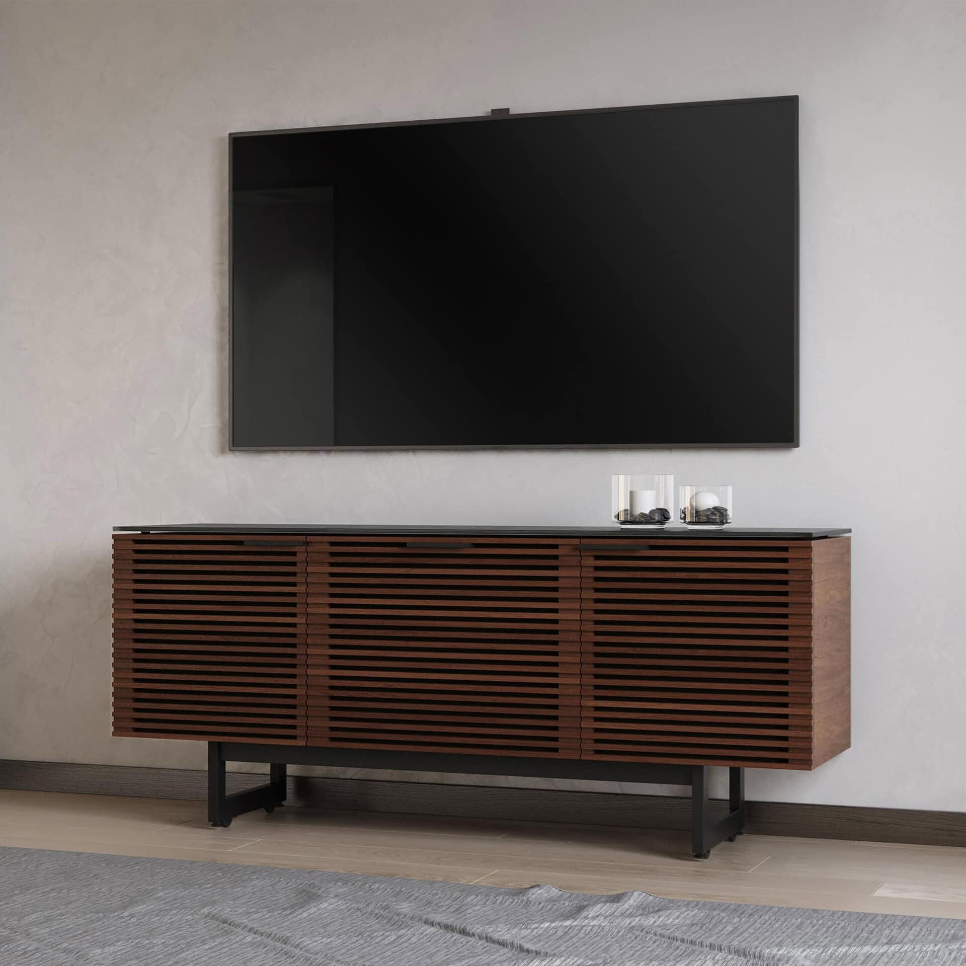 Mid-century modern wooden TV console with slatted design and black legs, perfect for contemporary living rooms.