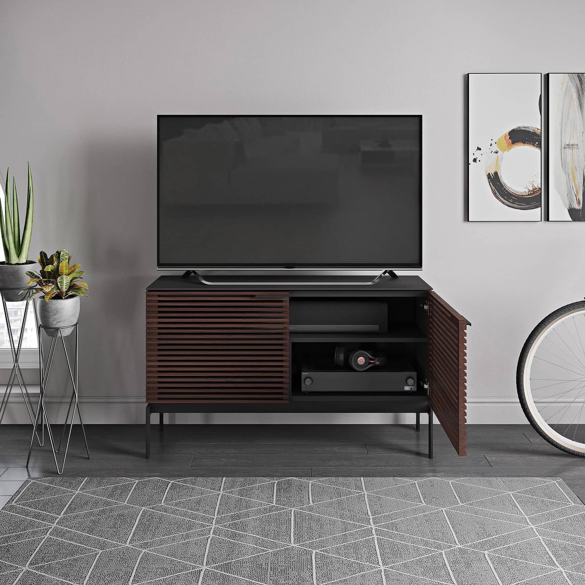 Contemporary wooden TV stand with louvered doors, sleek black top, and modern design for living room.