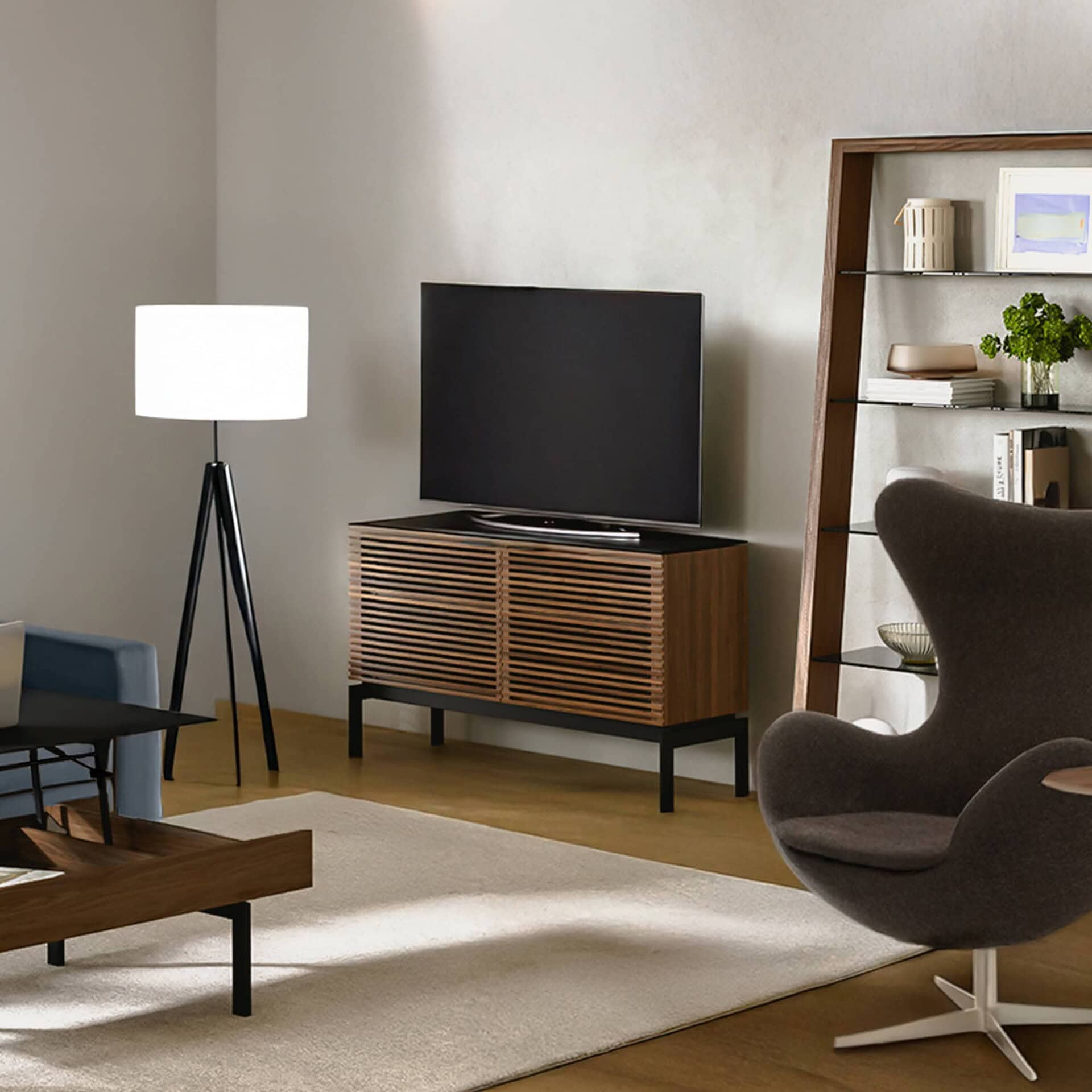 Stylish modern living room with wooden media console, armchair, and contemporary decor.
