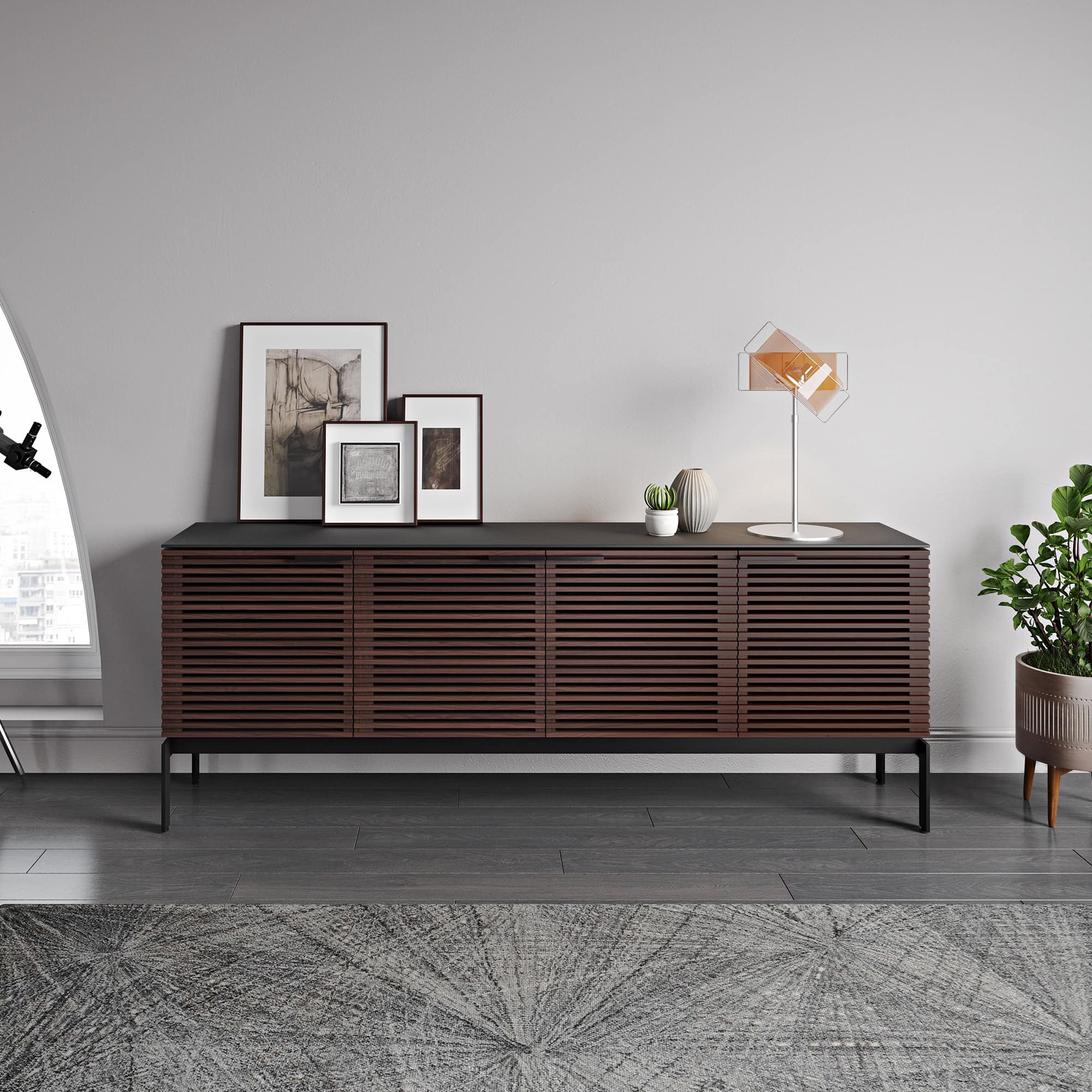 Stylish modern wooden sideboard with slatted doors and metal legs for contemporary interior decor.