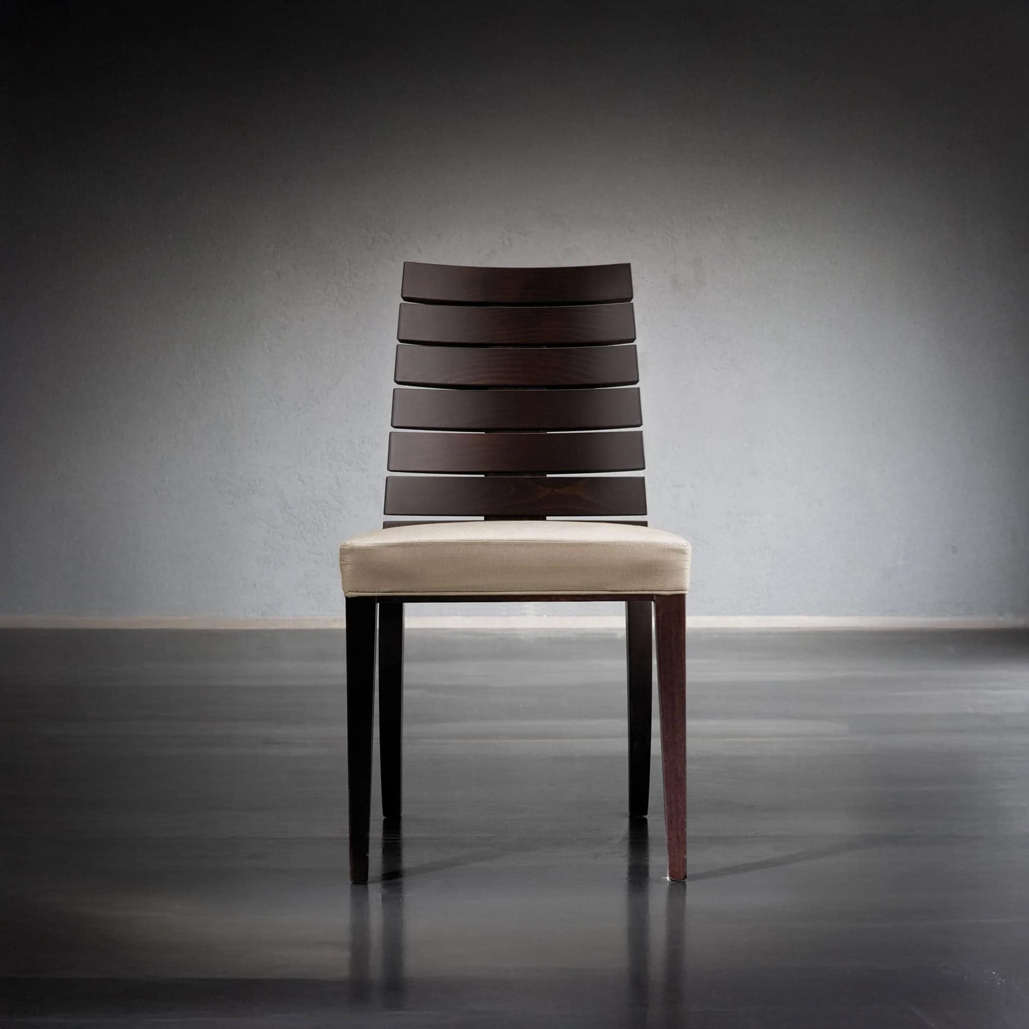Stylish dark wood chair with beige cushion, perfect for contemporary dining spaces.