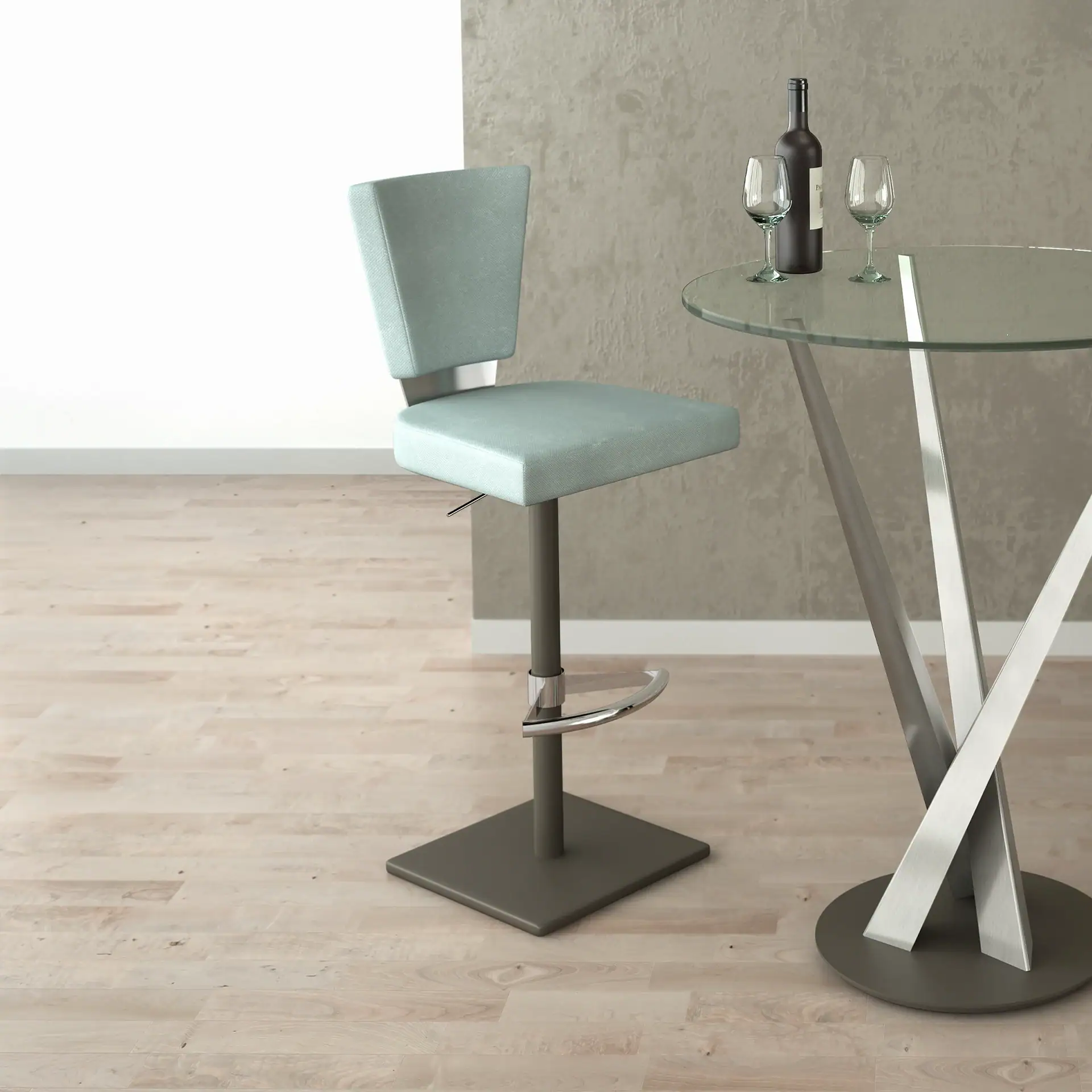 A light blue bar stool next to a round glass table with a wine bottle and two wine glasses on it. The room has light wooden floors and a textured gray wall.