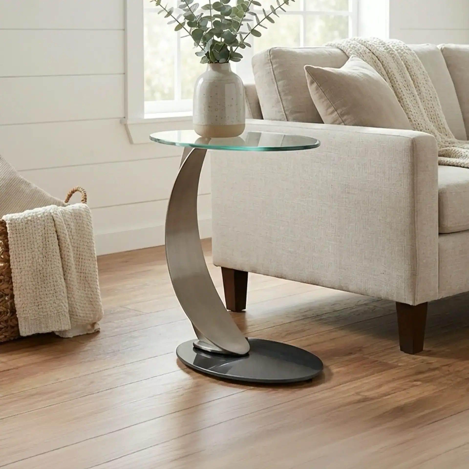 Contemporary living room furniture featuring a beige sofa and a unique side table with a glass top.