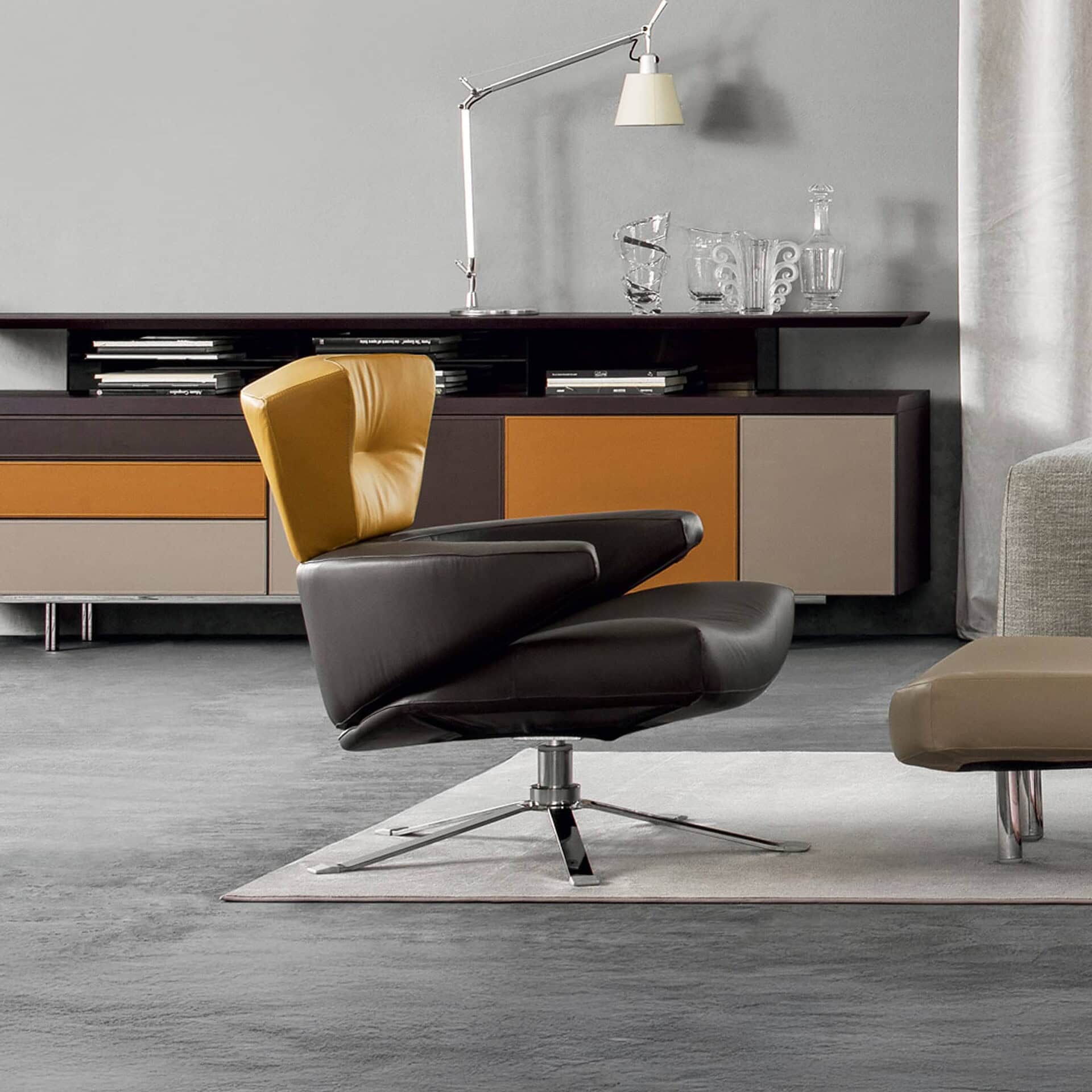 Mary Armchair in mustard yellow upholstery with ottoman on a swivel metal base.