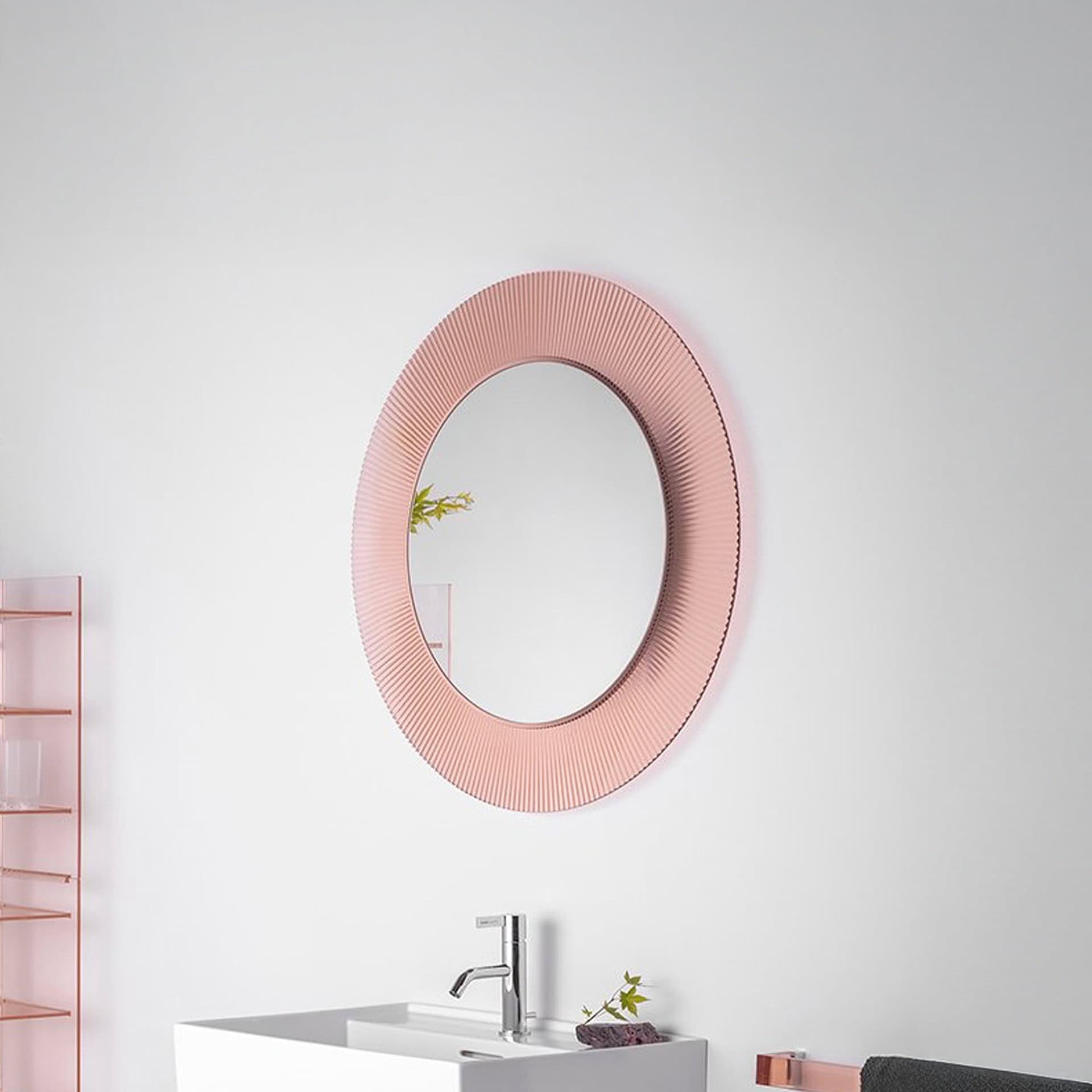 Kartell All Saints round mirror with pleated nude frame above vanity in a modern bathroom.