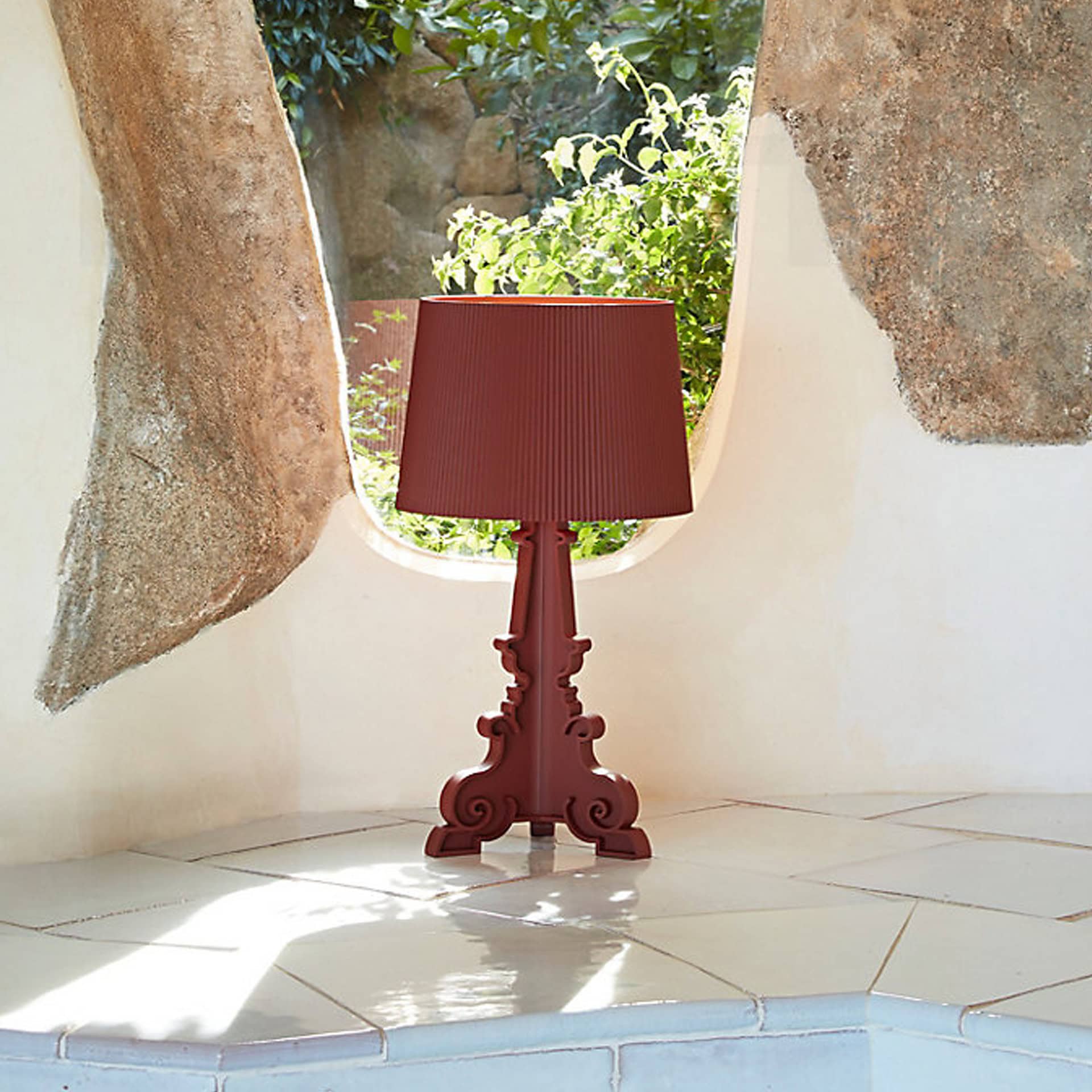 Red table lamp with decorative base, perfect for stylish home decor.