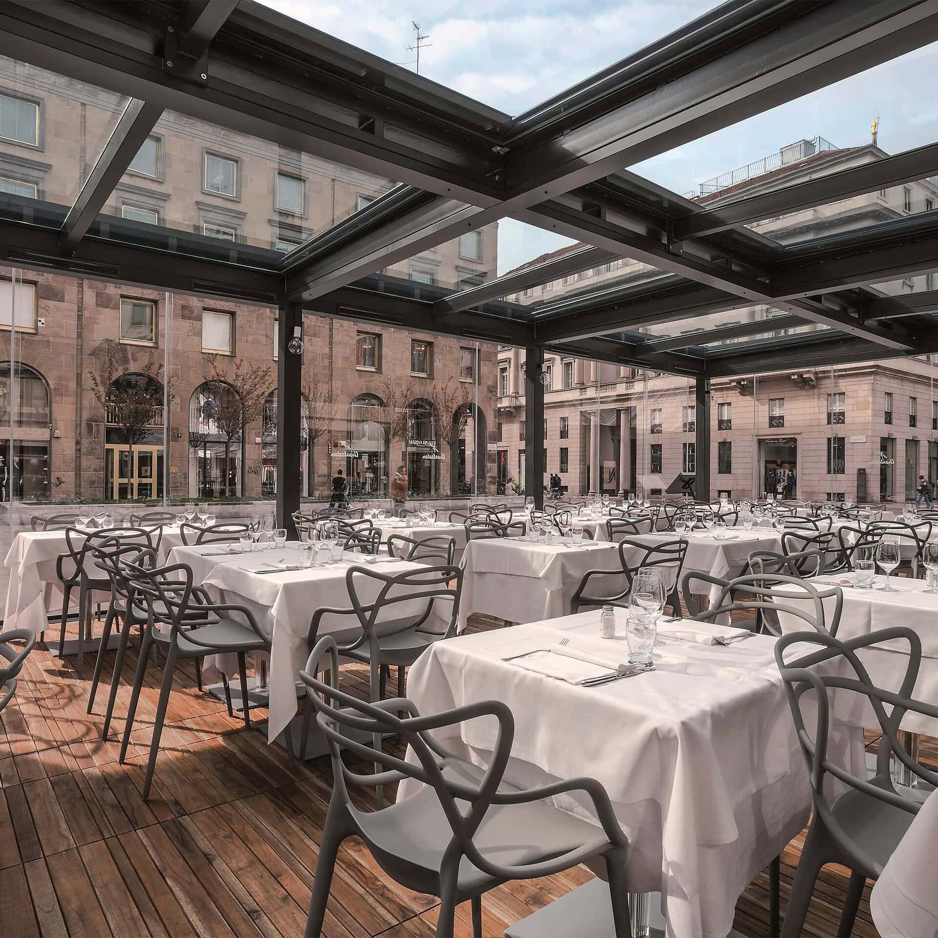 Masters Dining Chairs in grey, stylish outdoor terrace dining arrangement by Kartell