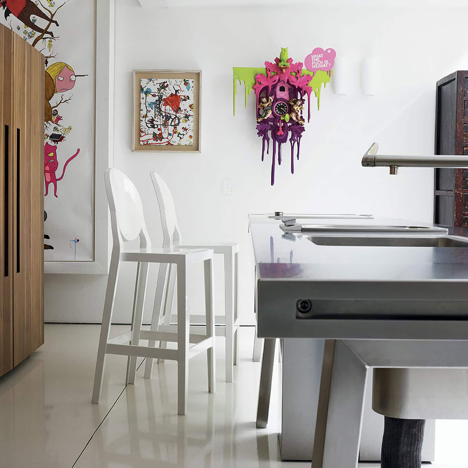 White Kartell One More stools styled in a bright kitchen with flowers on the counter.