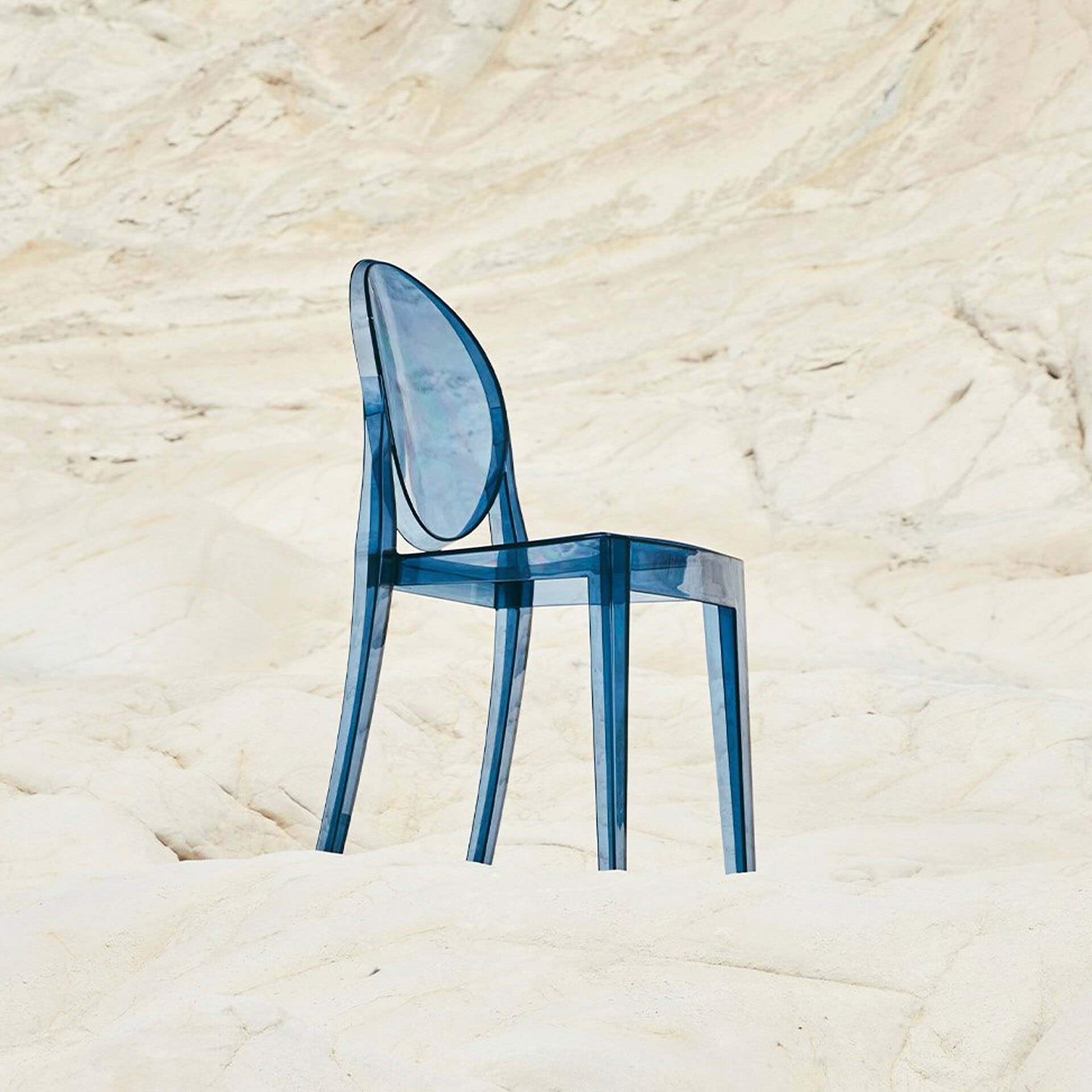 Blue acrylic chair with sleek design and transparent finish.