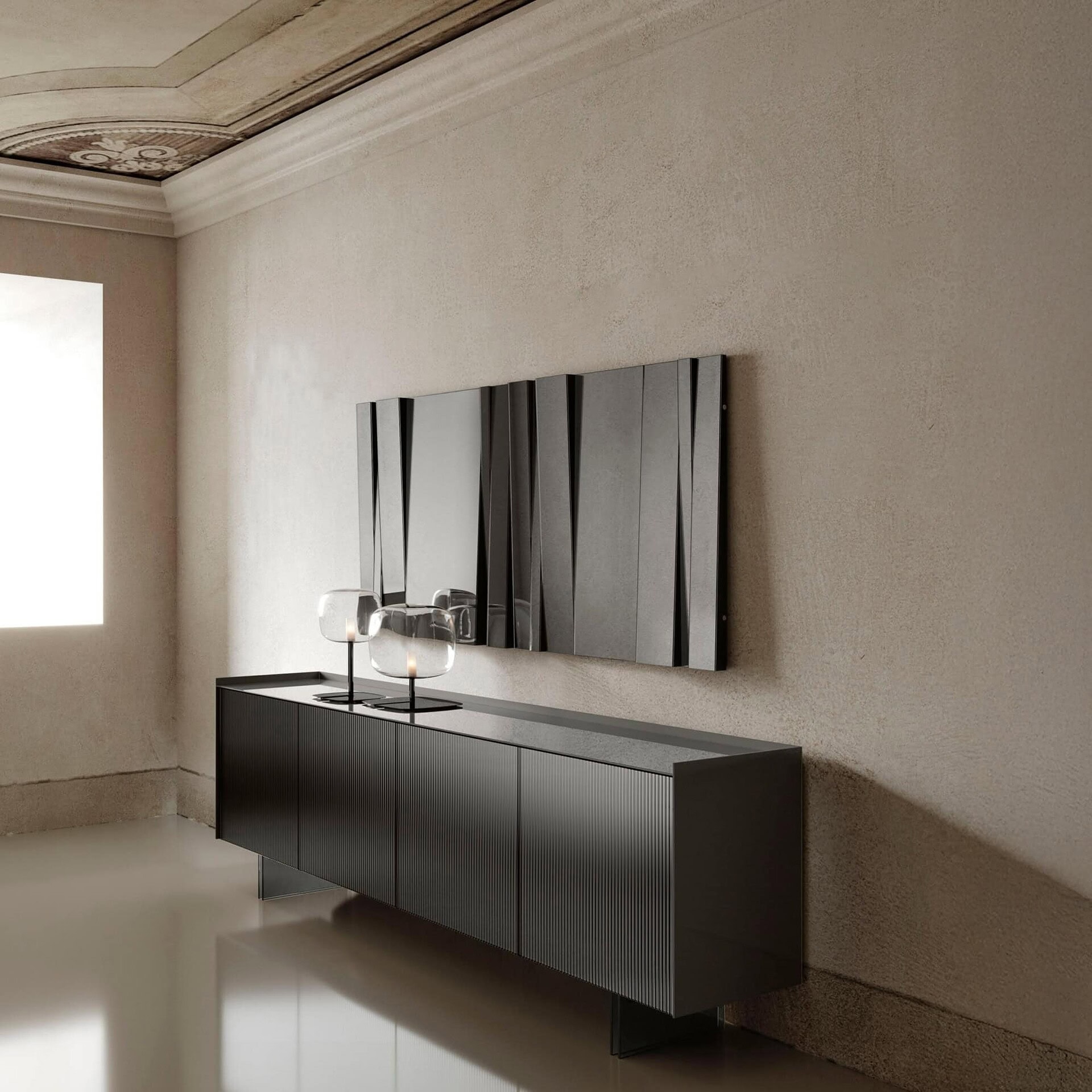 Fittipaldi Mirror spanning wall above console in elegant interior.