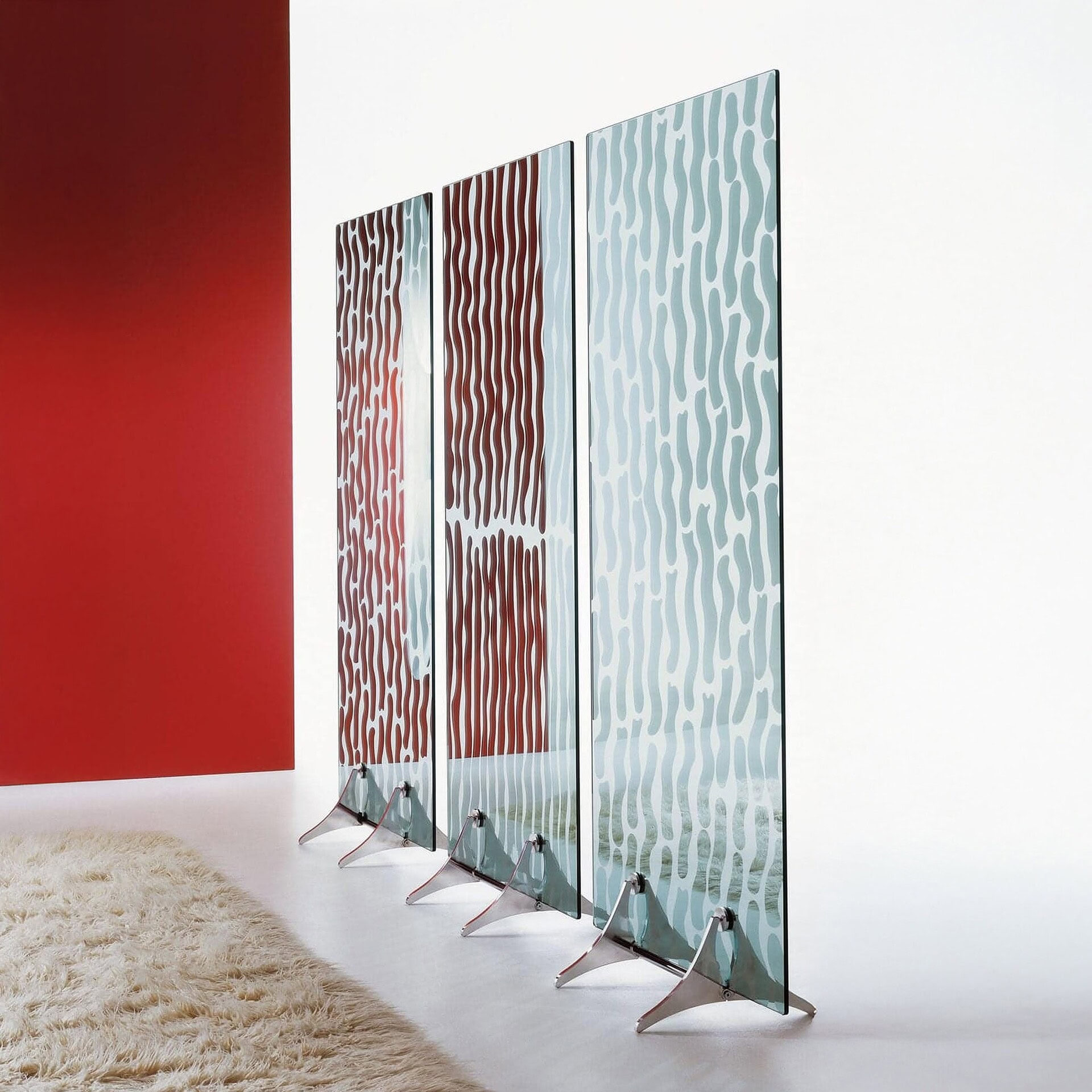 can I get an alt description for this image ChatGPT said: Here’s a clear, SEO-friendly alt description for your image: Alt Text: Pixel Room Divider by Tonelli Design featuring tall glass panels with mirrored wave patterns and polished chrome supports, used as a modern decorative partition in a contemporary living space.