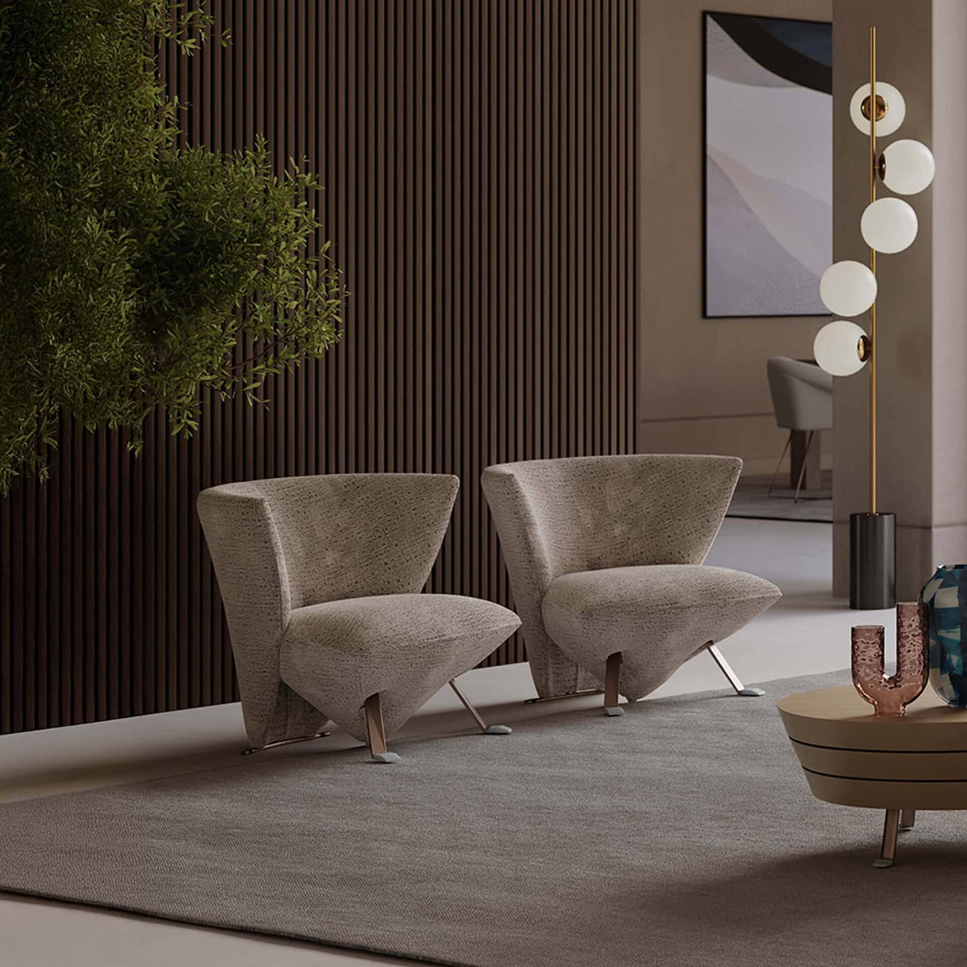 Pair of Jade Sculptural Armchairs in beige fabric set in a modern living room with wood panel wall and neutral rug.