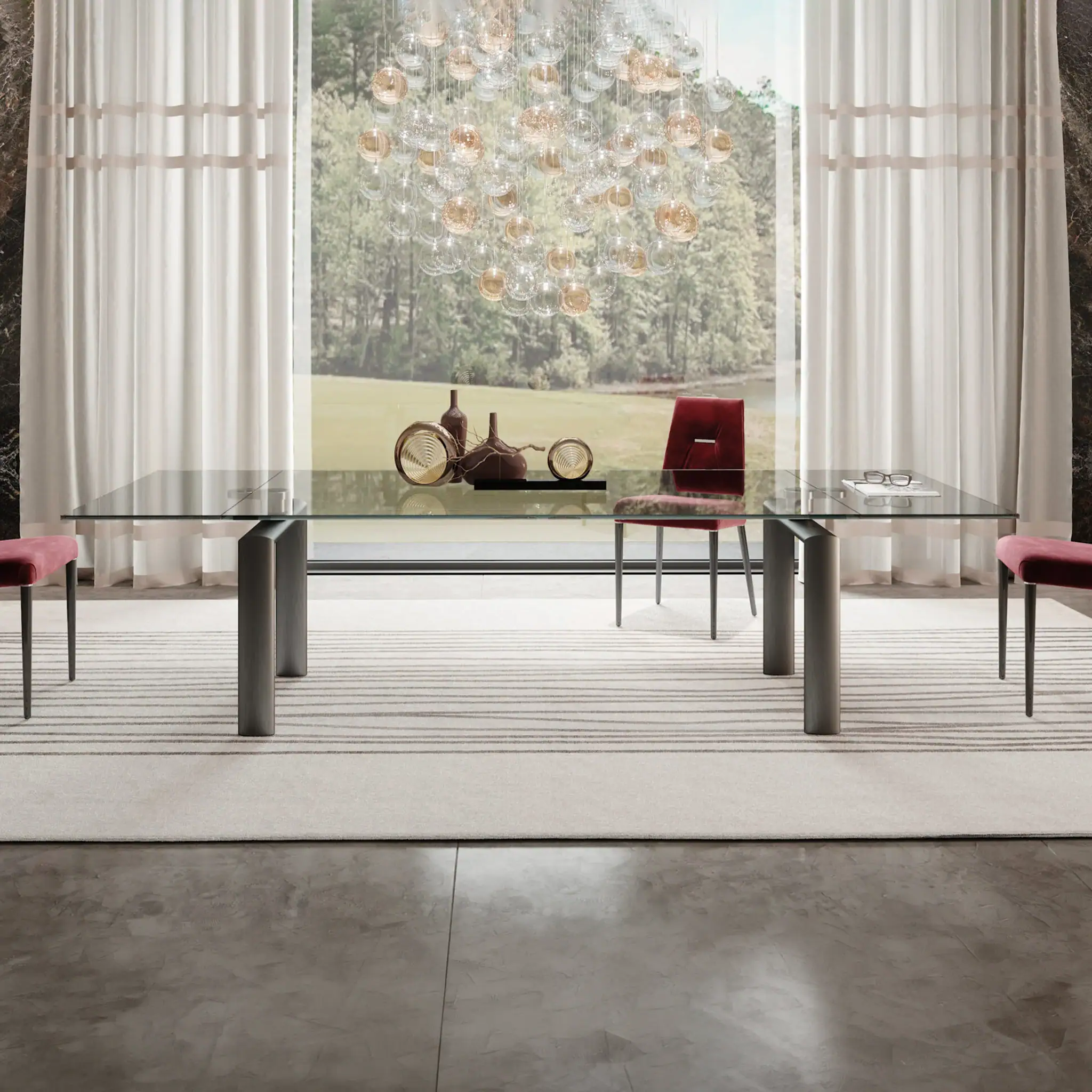 Modern glass extending dining table with pink chairs in bright room.