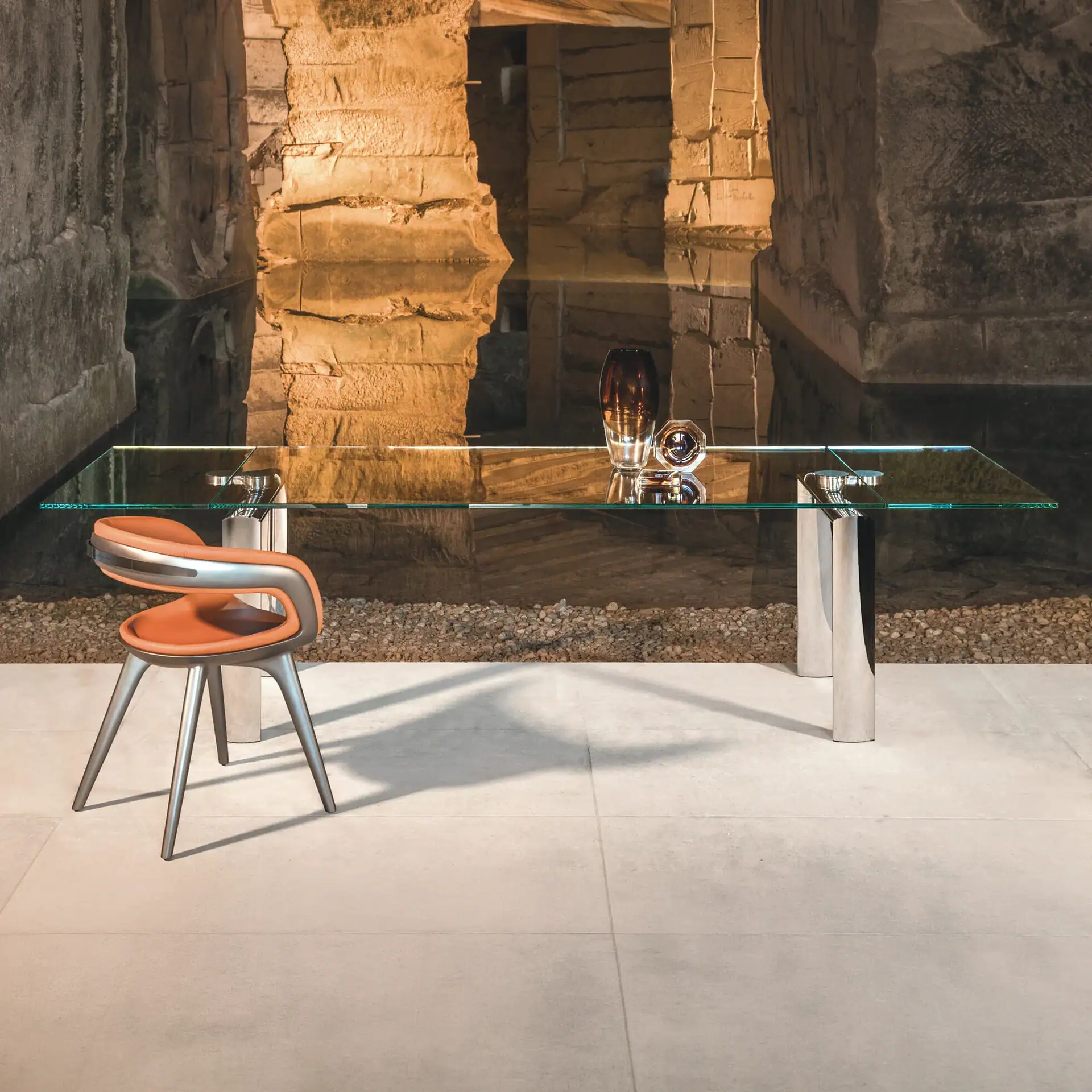 Modern extendable glass dining table with unique base in a stylish setting.