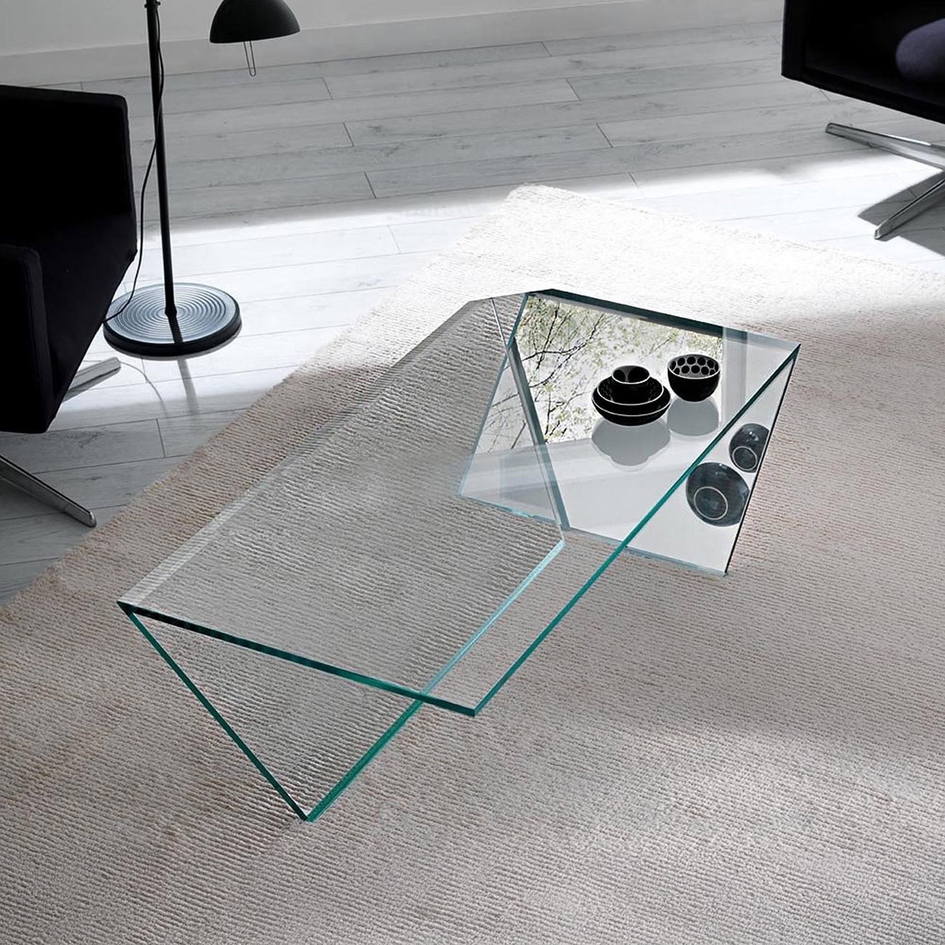 Ti Low Table in transparent glass, shown in a bright interior with minimalist decor accents.