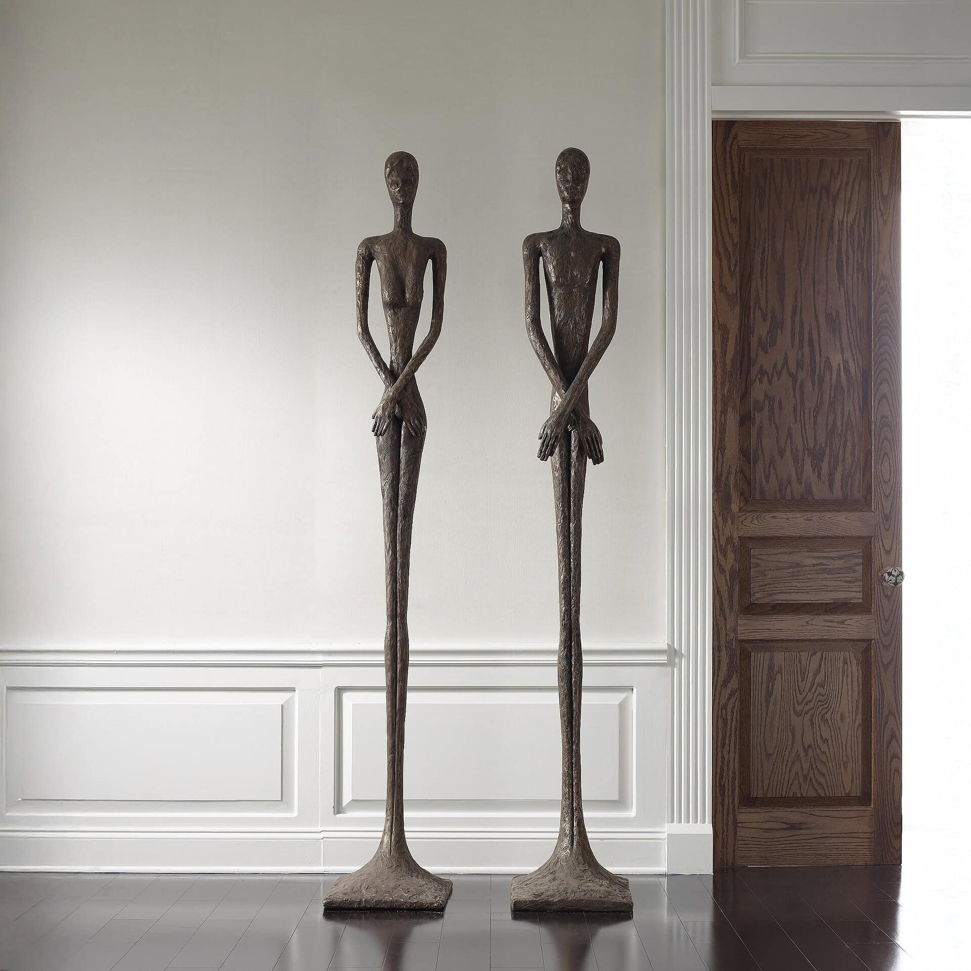 Bronze finish elongated modern sculptures for stylish interior design, adding artistic elegance to your living space.