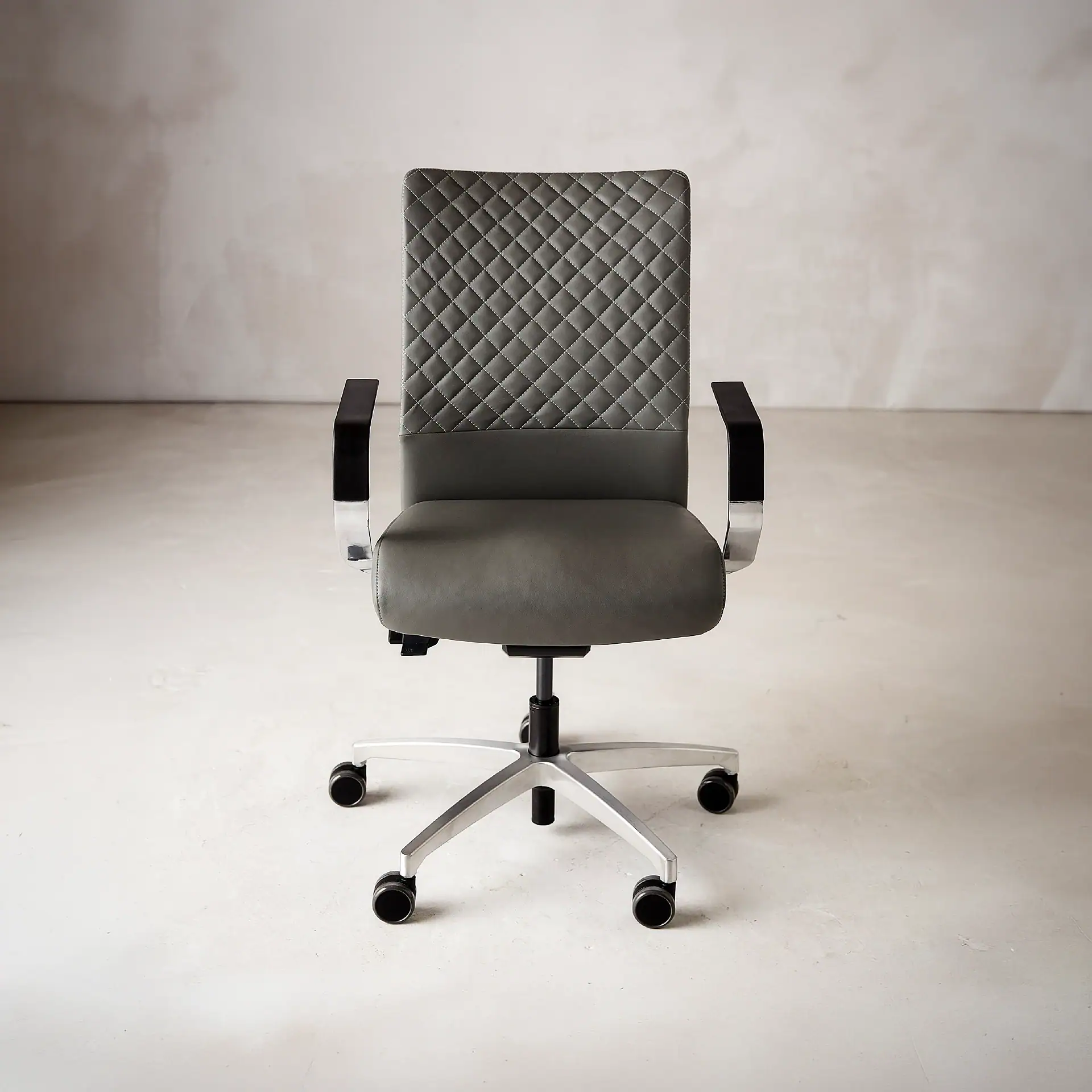 Sklar Furnishings Proform office chair with quilted backrest and armrests.