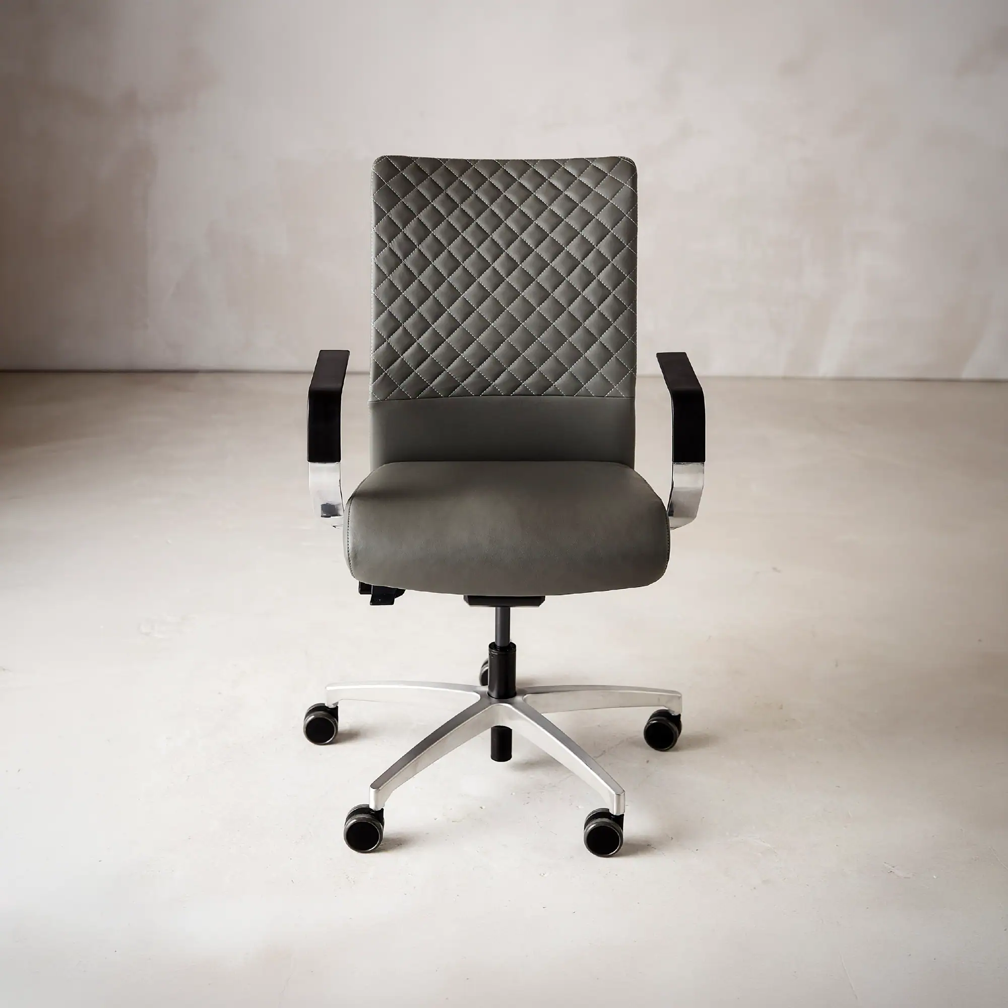 Sklar Furnishings Proform office chair with quilted backrest and armrests.