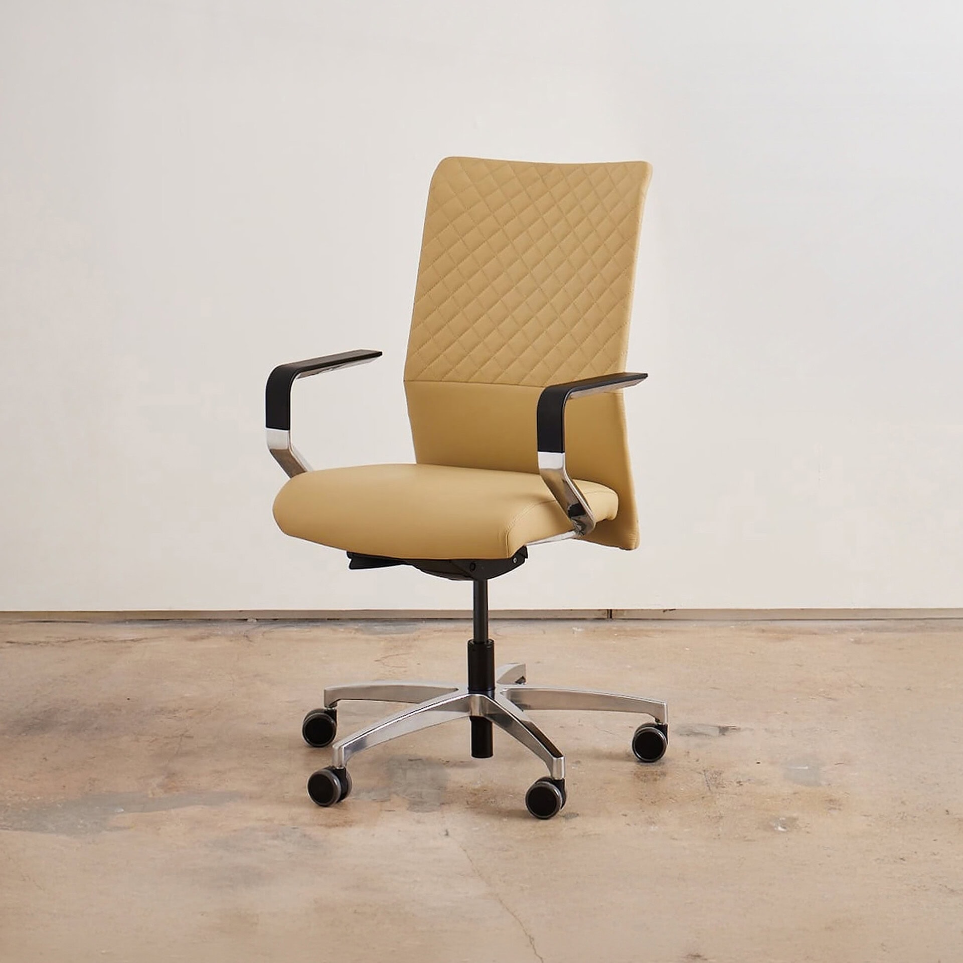 Modern beige upholstered office chair with armrests and adjustable height.