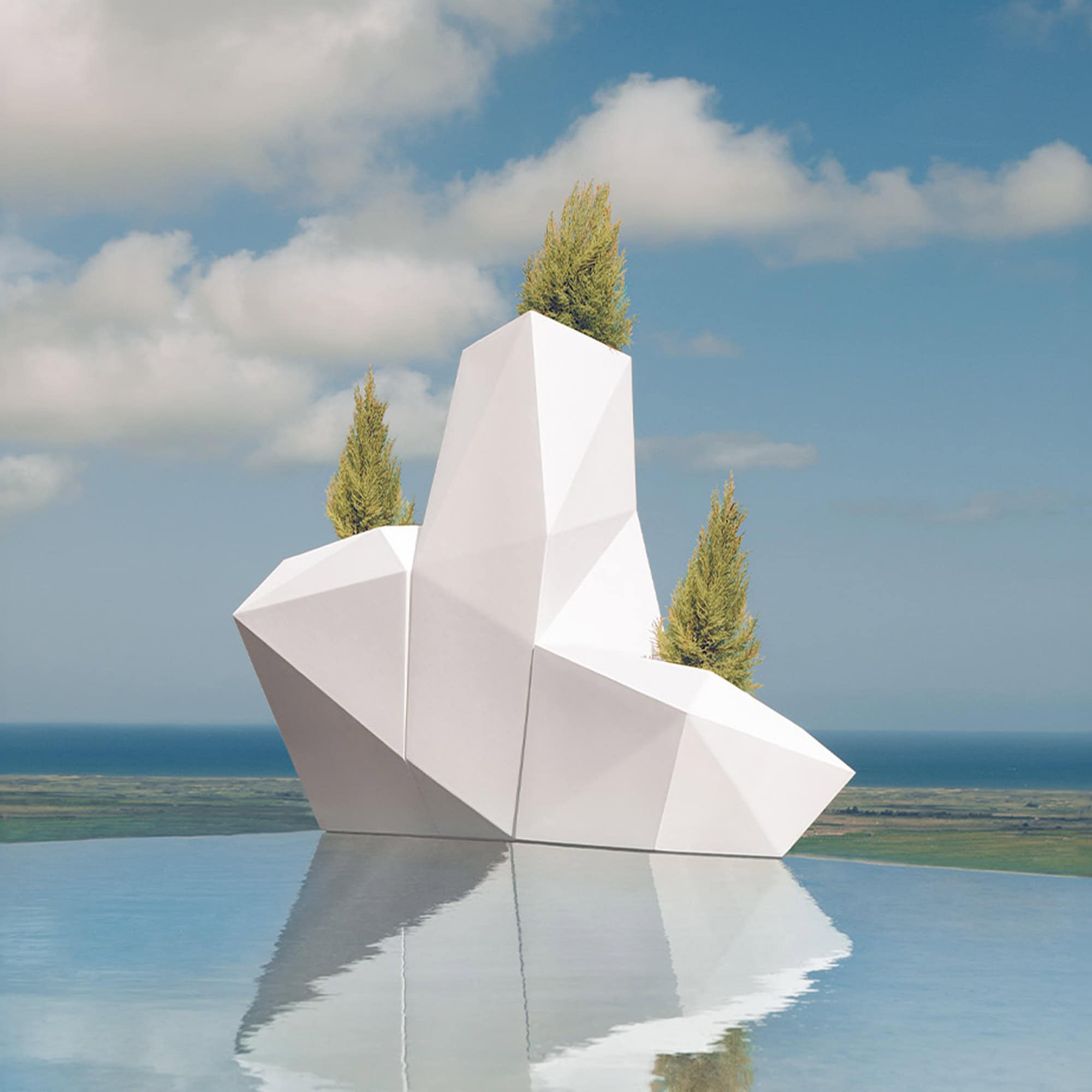 Modern geometric outdoor sculpture with trees, overlooking water.