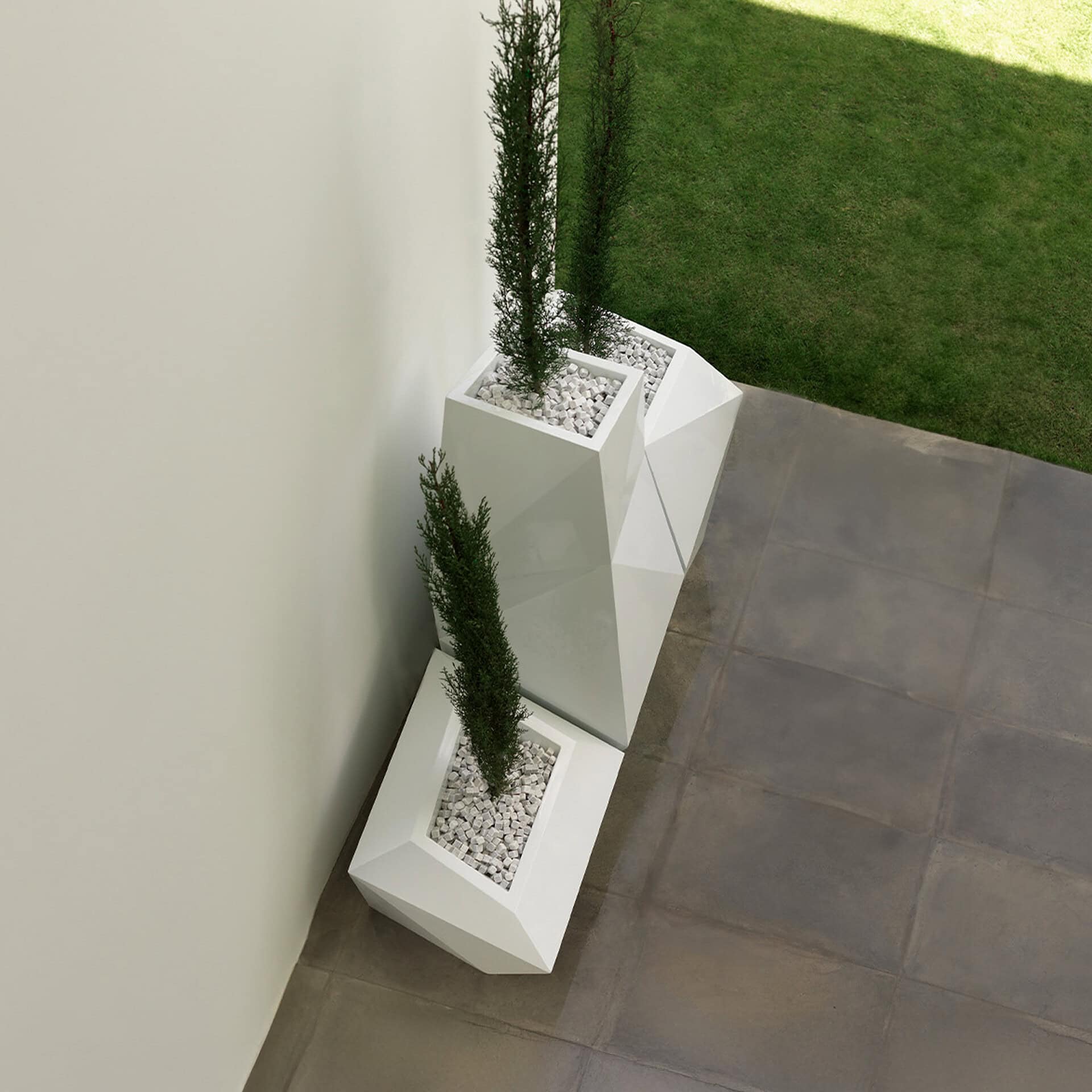 Outdoor planters with tall green plants on a modern patio.