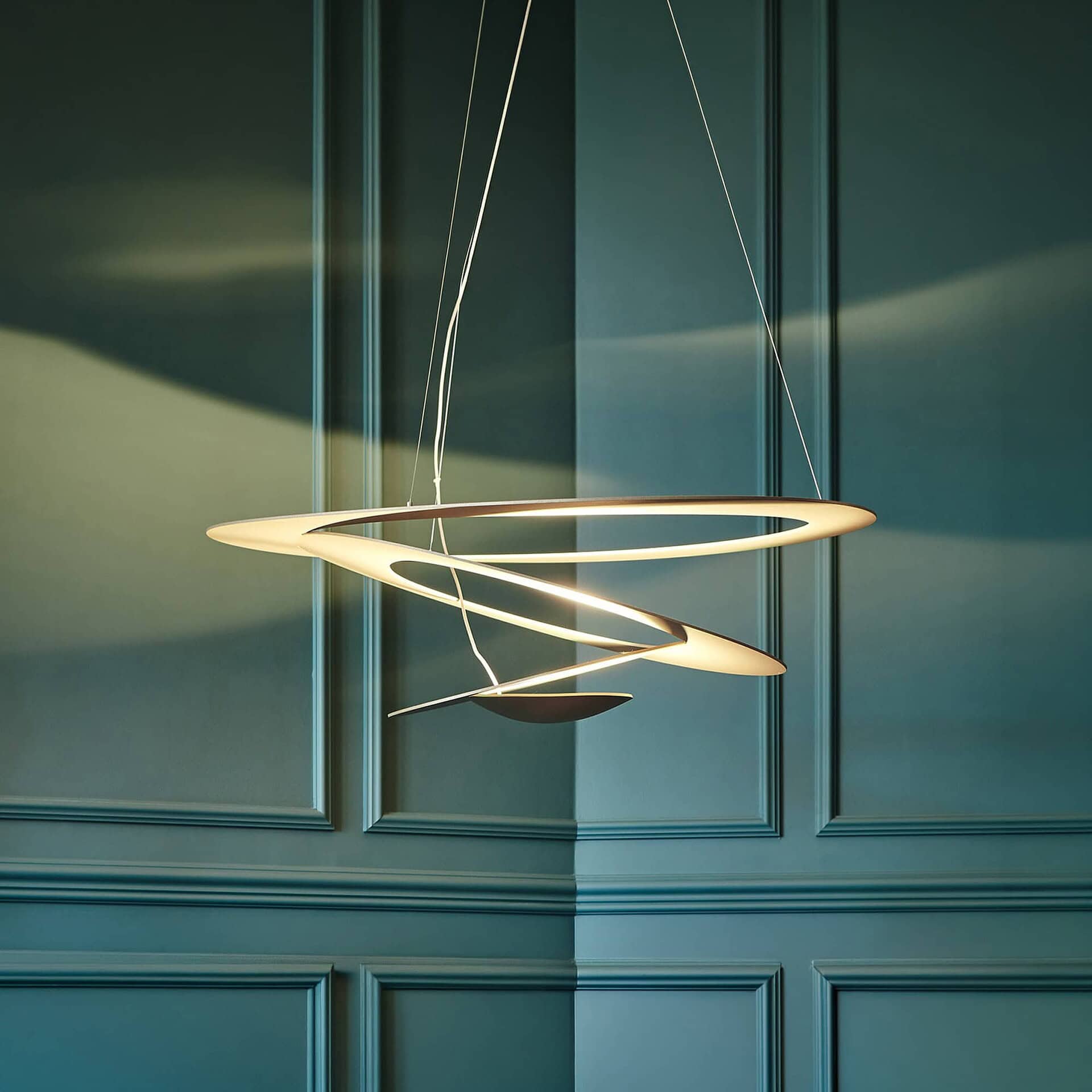Modern Artemide pendant light with sleek, sculptural design.