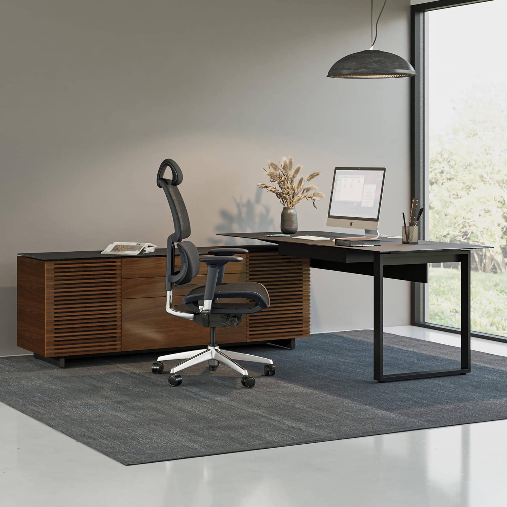 Contemporary BDI office desk with storage cabinet and ergonomic chair.