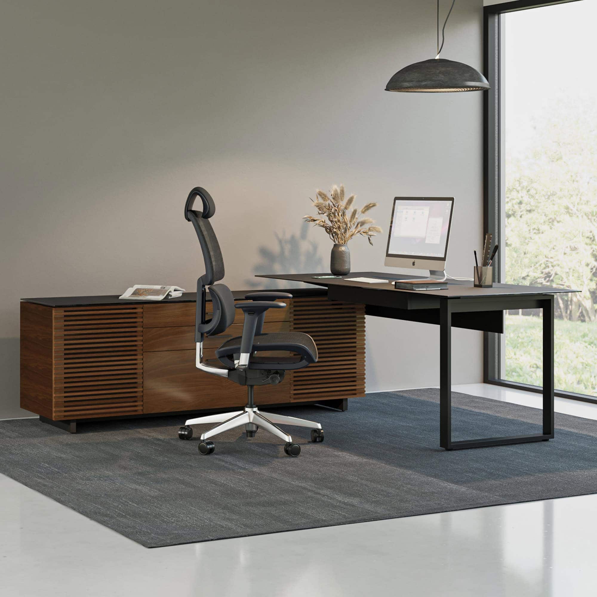 Contemporary BDI office desk with storage cabinet and ergonomic chair.