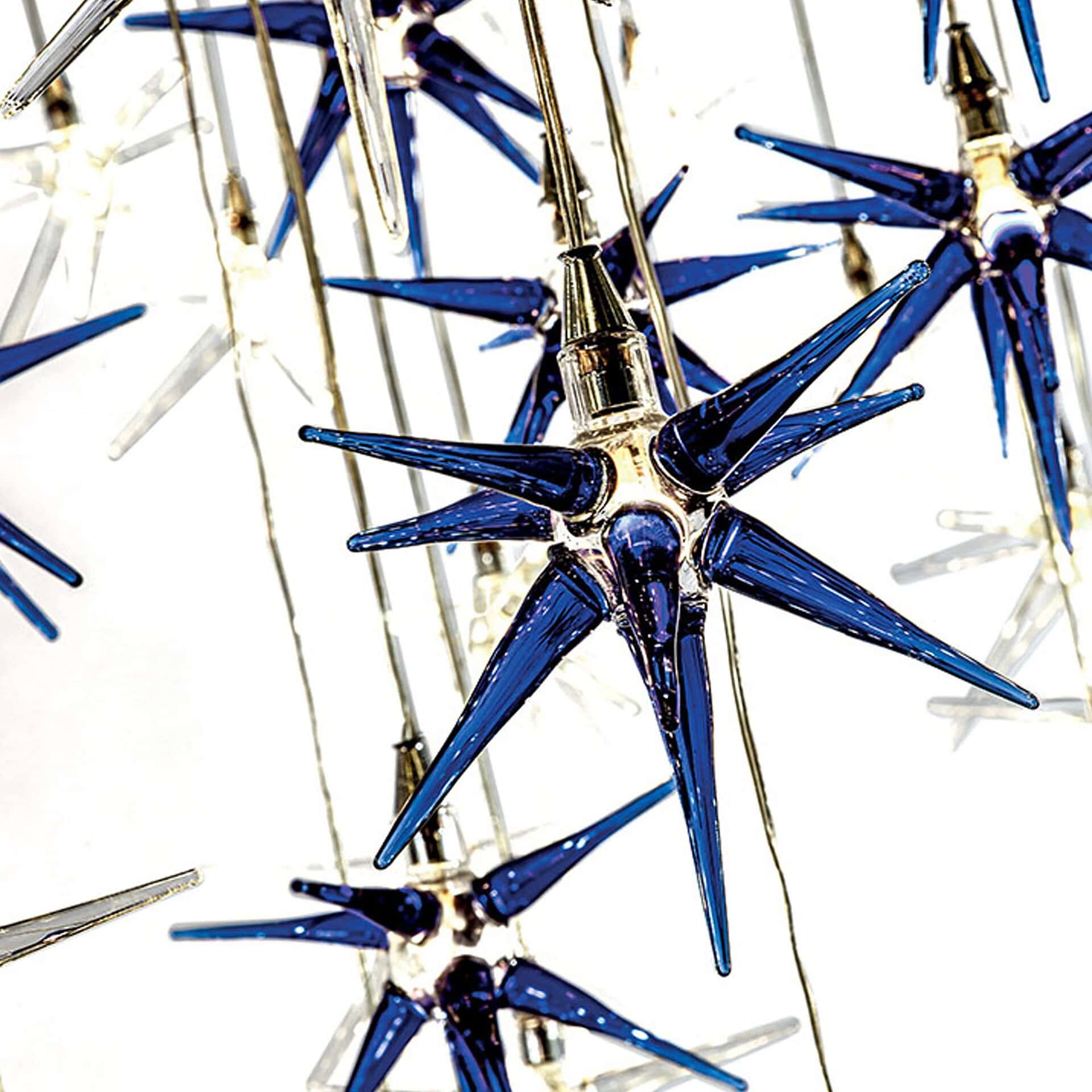 Close-up of Stella Celestial Glass Chandelier elements in transparent and blue borosilicate glass.