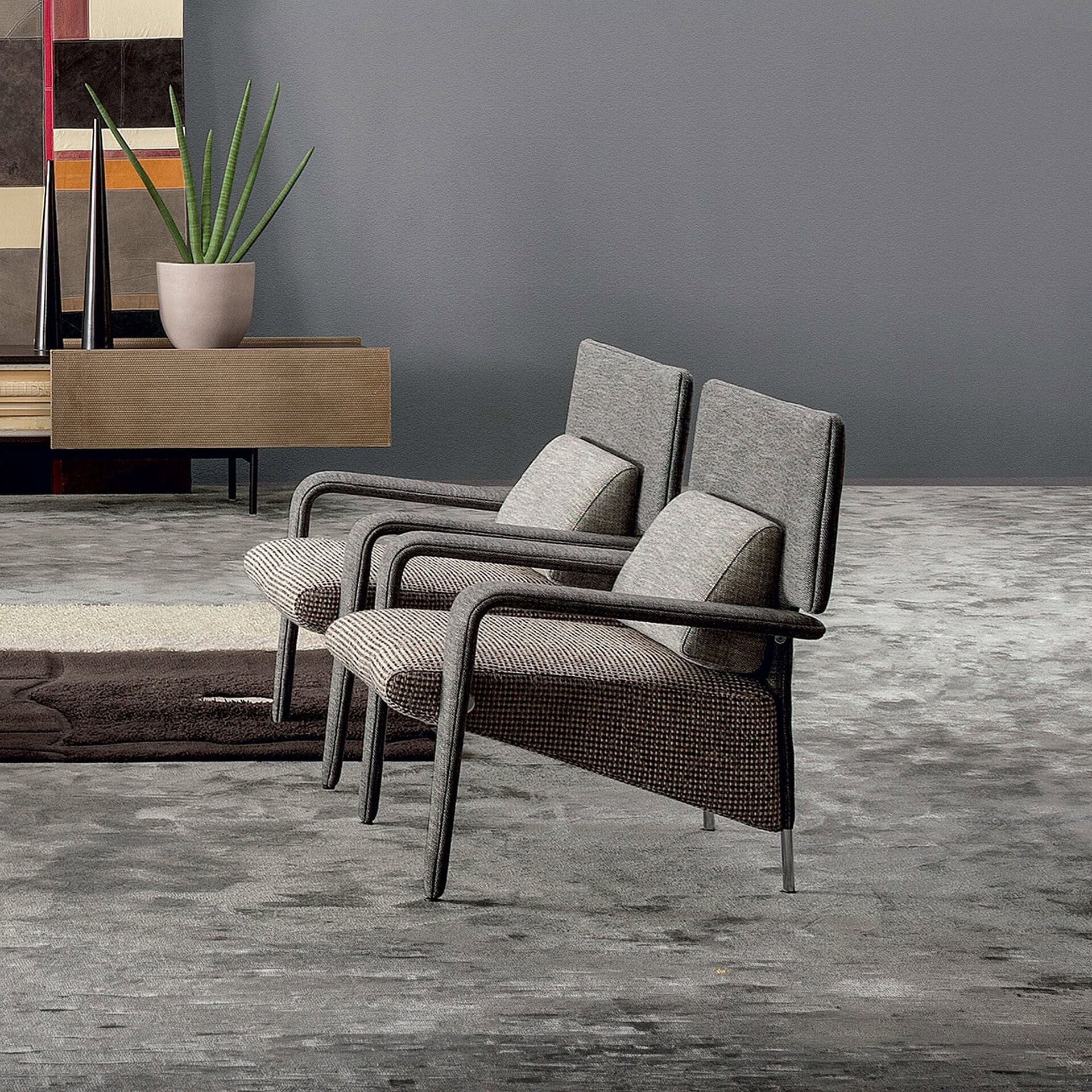 Modern mid-century style armchairs with upholstered cushions and dark wooden arms.