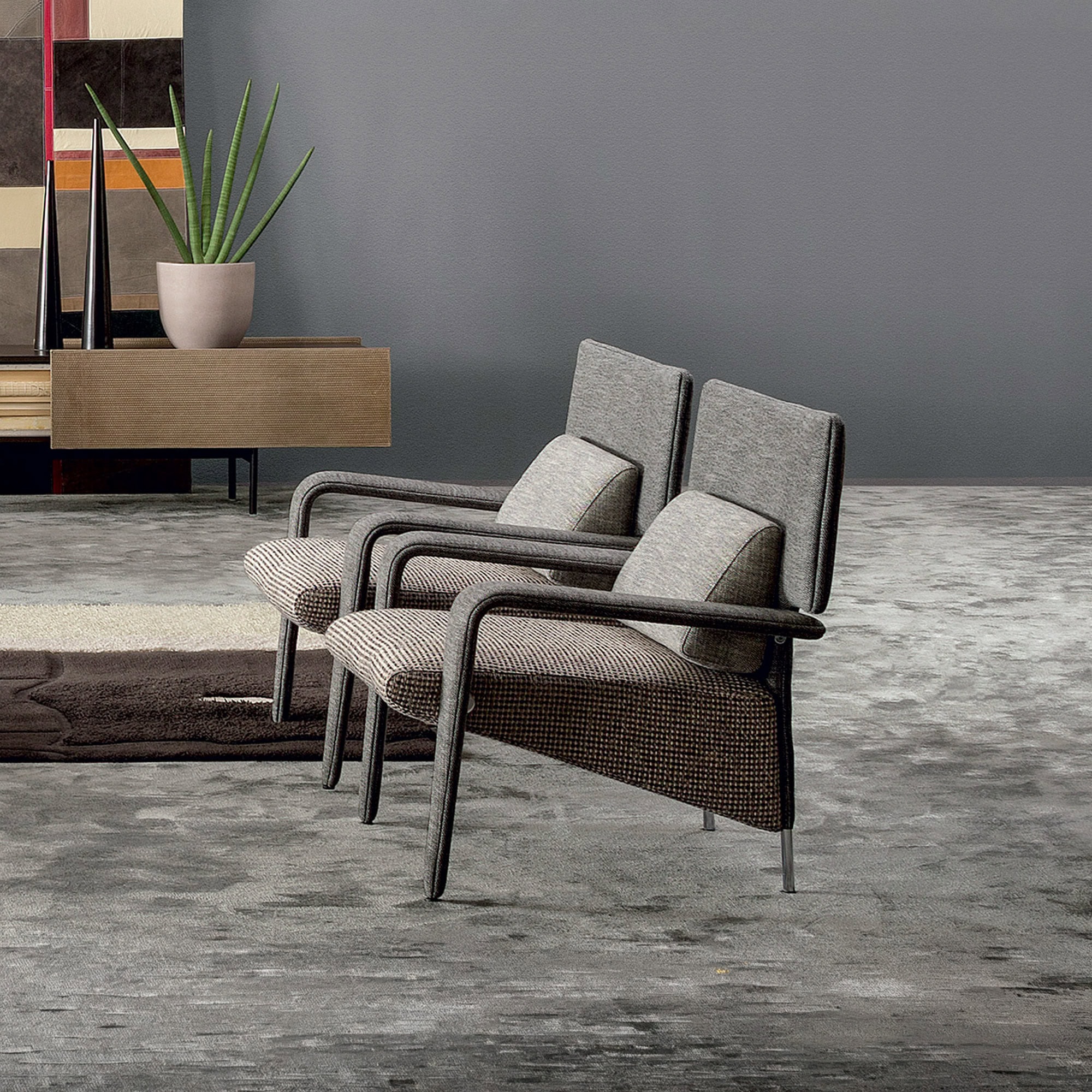 Modern mid-century style armchairs with upholstered cushions and dark wooden arms.