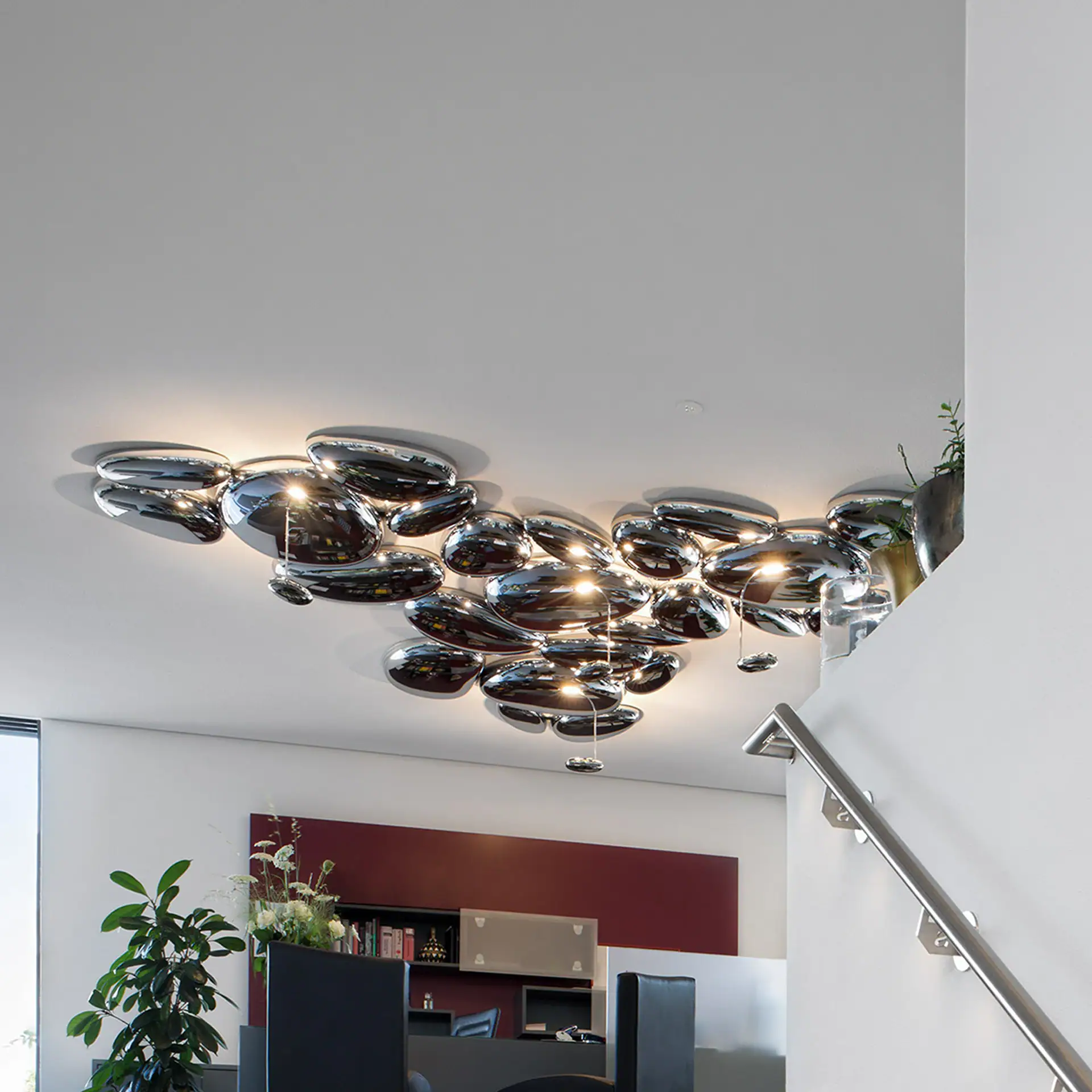 Modern chrome bubble ceiling light fixture in contemporary office interior.