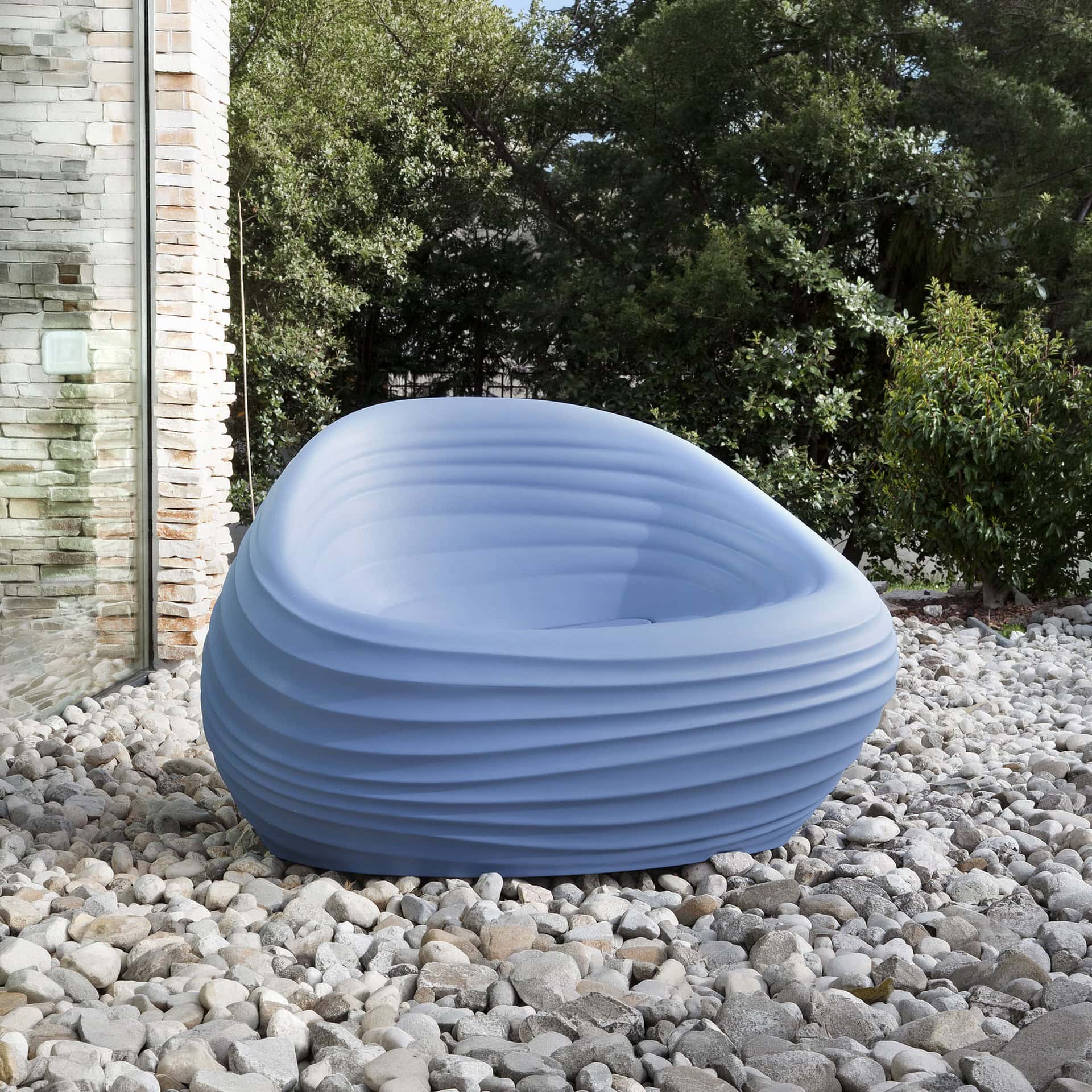 Sculptural lounge chair by Sklar Furnishings, perfect for outdoor relaxation.