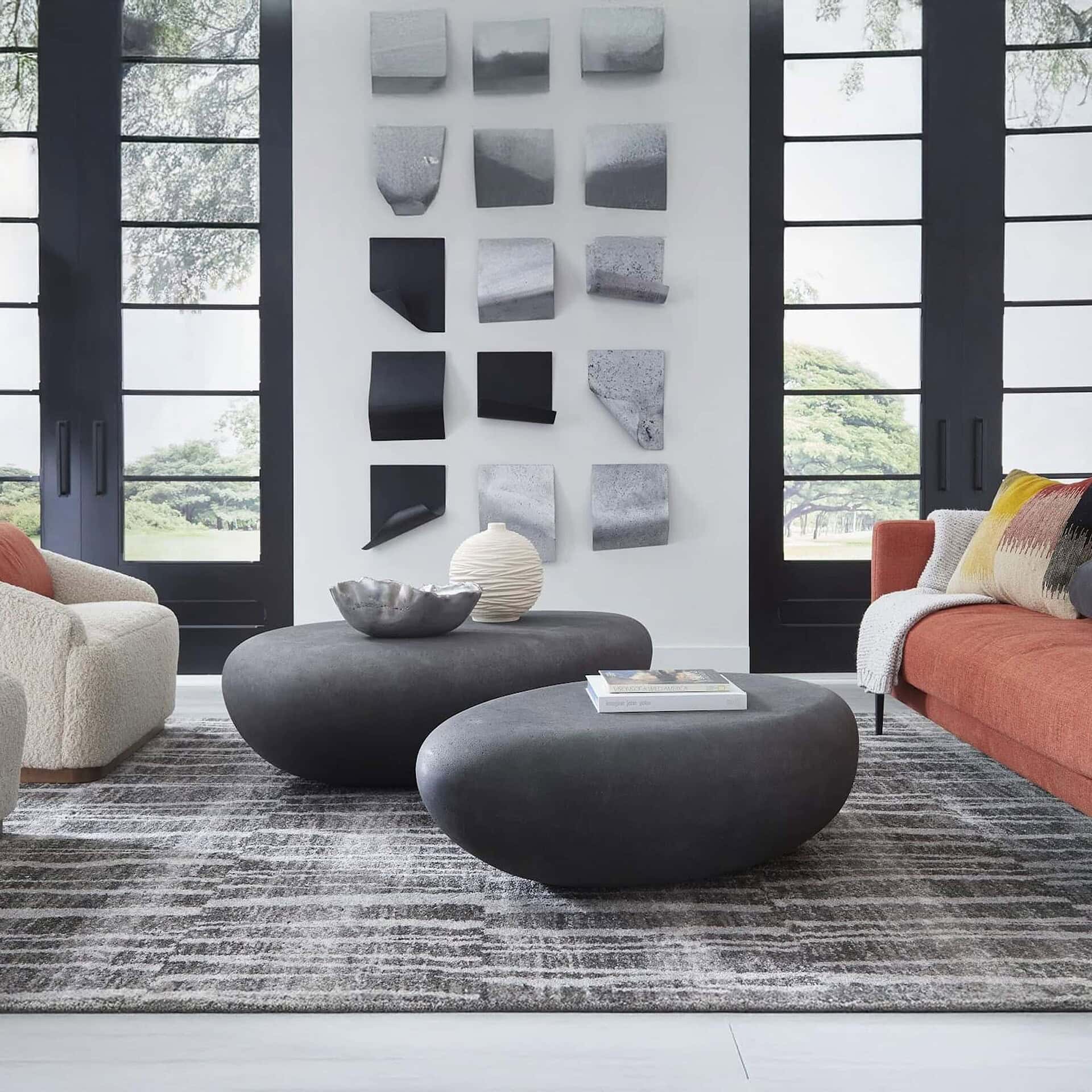 Charcoal Stone River Stone Coffee Tables in modern living room with gray sofa.
