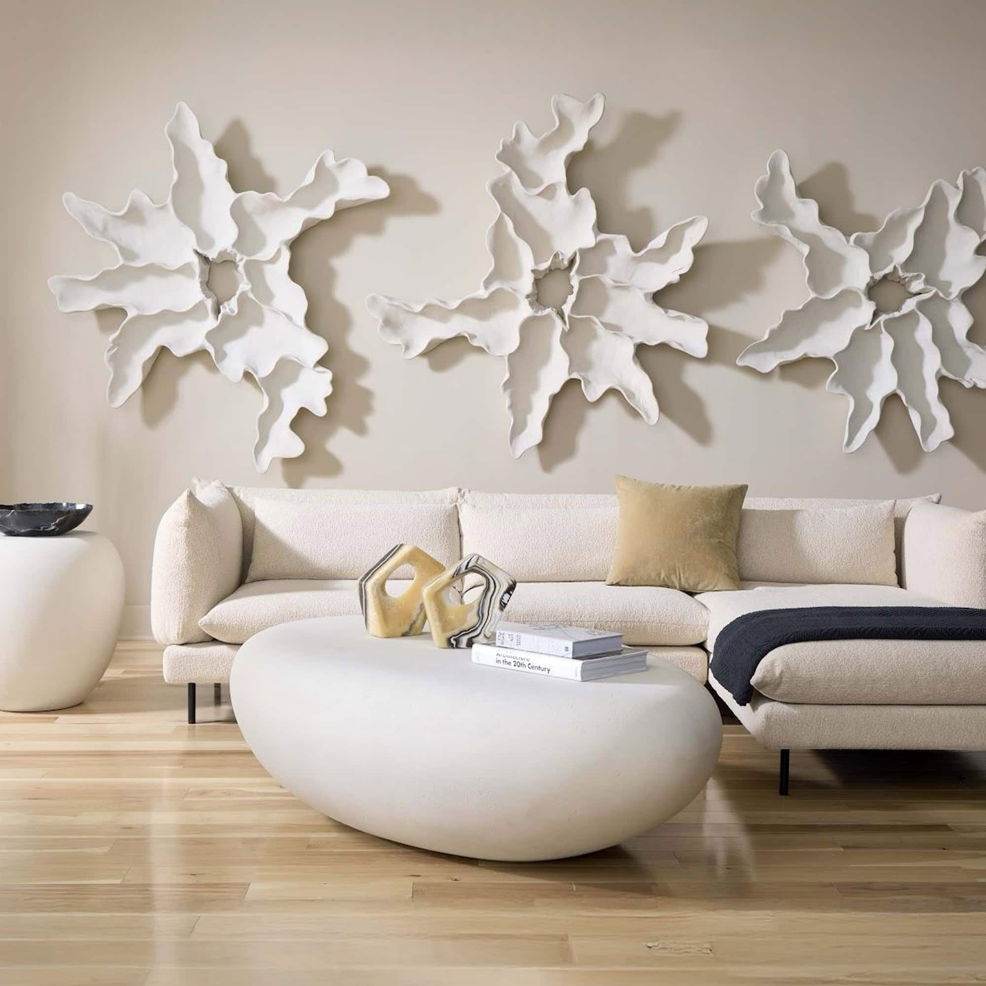 White Gel Coat River Stone Coffee Table styled with natural accents in airy living room.