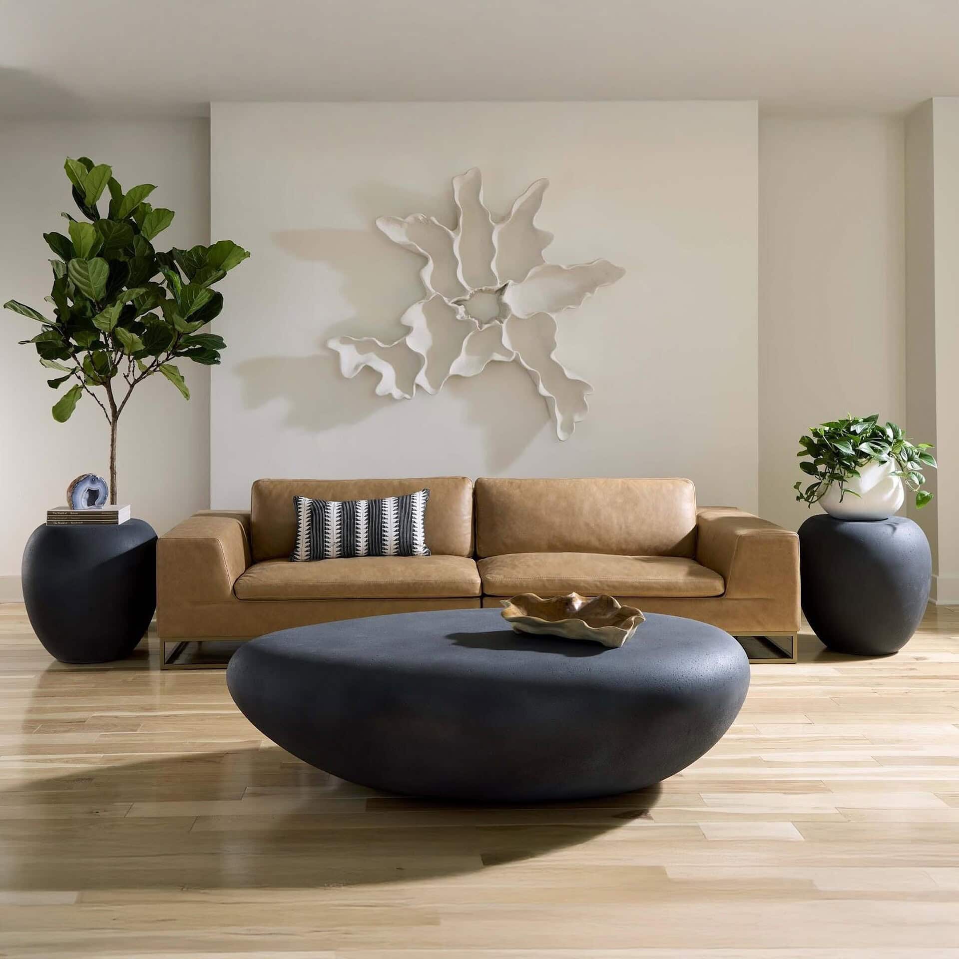 Charcoal Stone River Stone Coffee Table styled in a bright interior with wall décor.”
