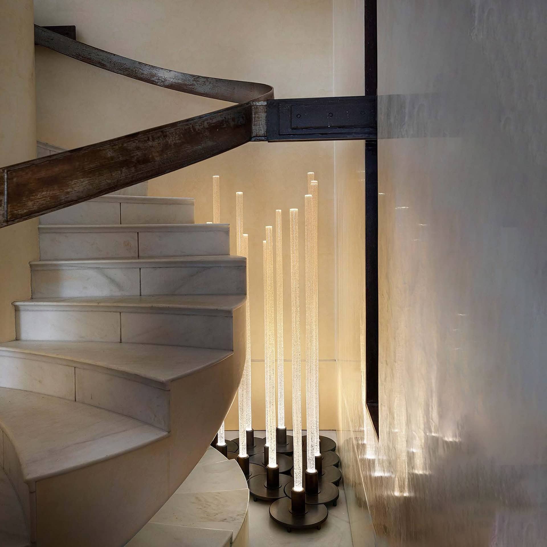 Modern staircase with elegant lighting at Sklar Furnishings showroom.