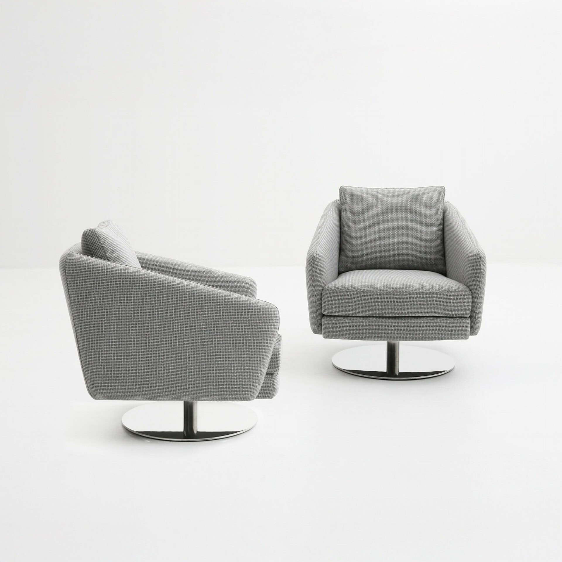 Pair of Regis Upholstered Swivel Chairs in light gray fabric, one facing forward and the other angled, both with chrome swivel bases against a white background.