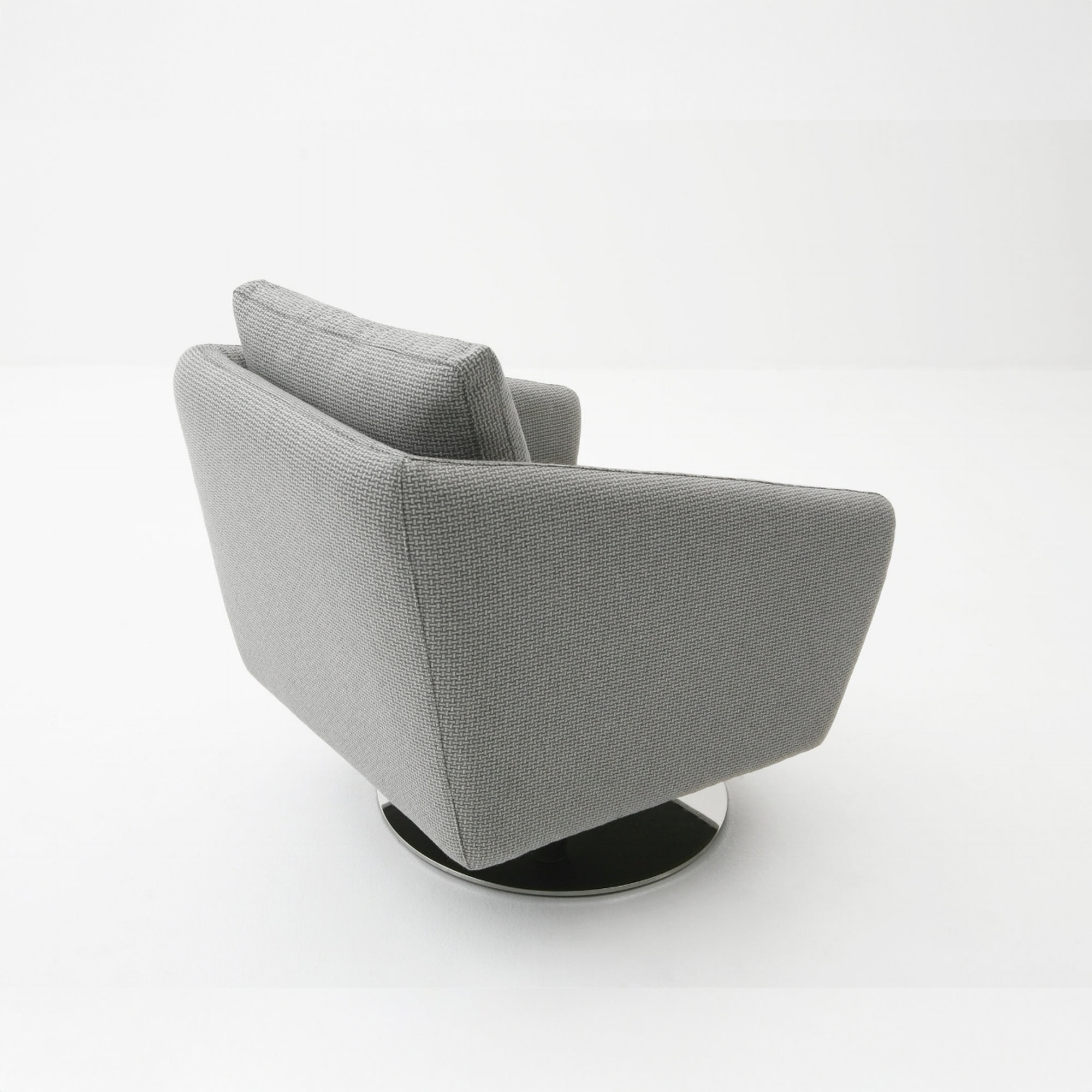Side and back view of a Regis Upholstered Swivel Chair in light gray fabric, highlighting its angular armrests and polished swivel base.