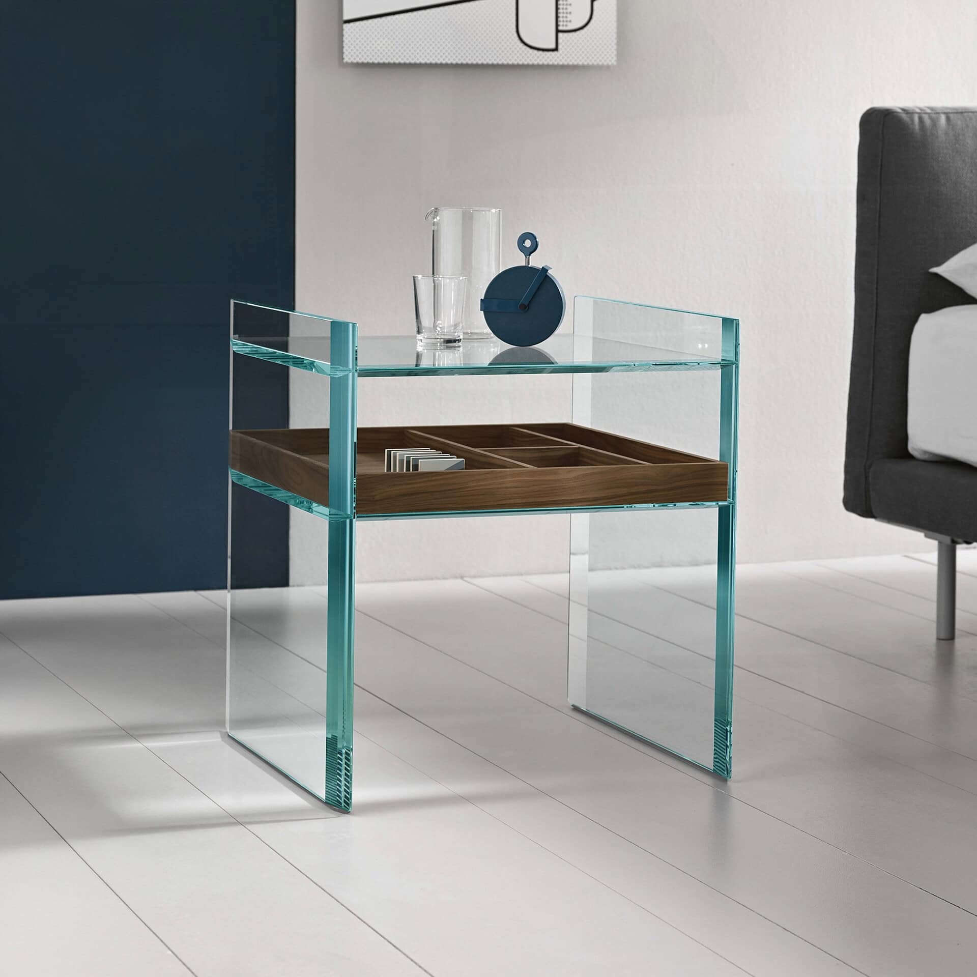 Elegant glass and wood side table with storage tray, perfect for contemporary living spaces.