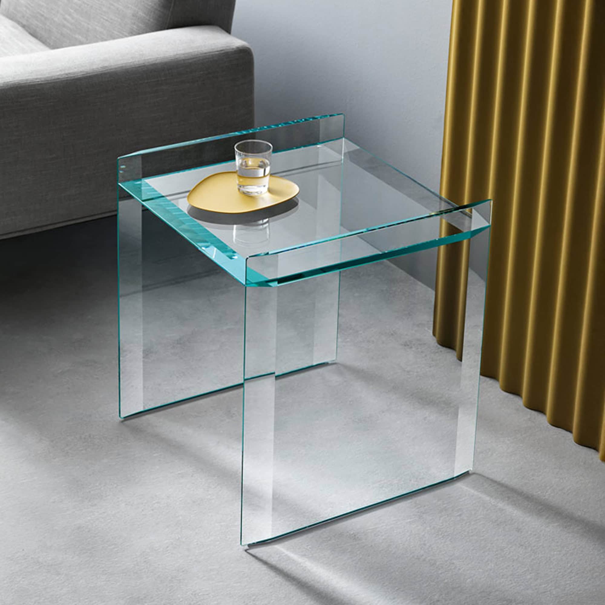 Quiller side table with shelf placed beside a sofa, styled with tray and drink.