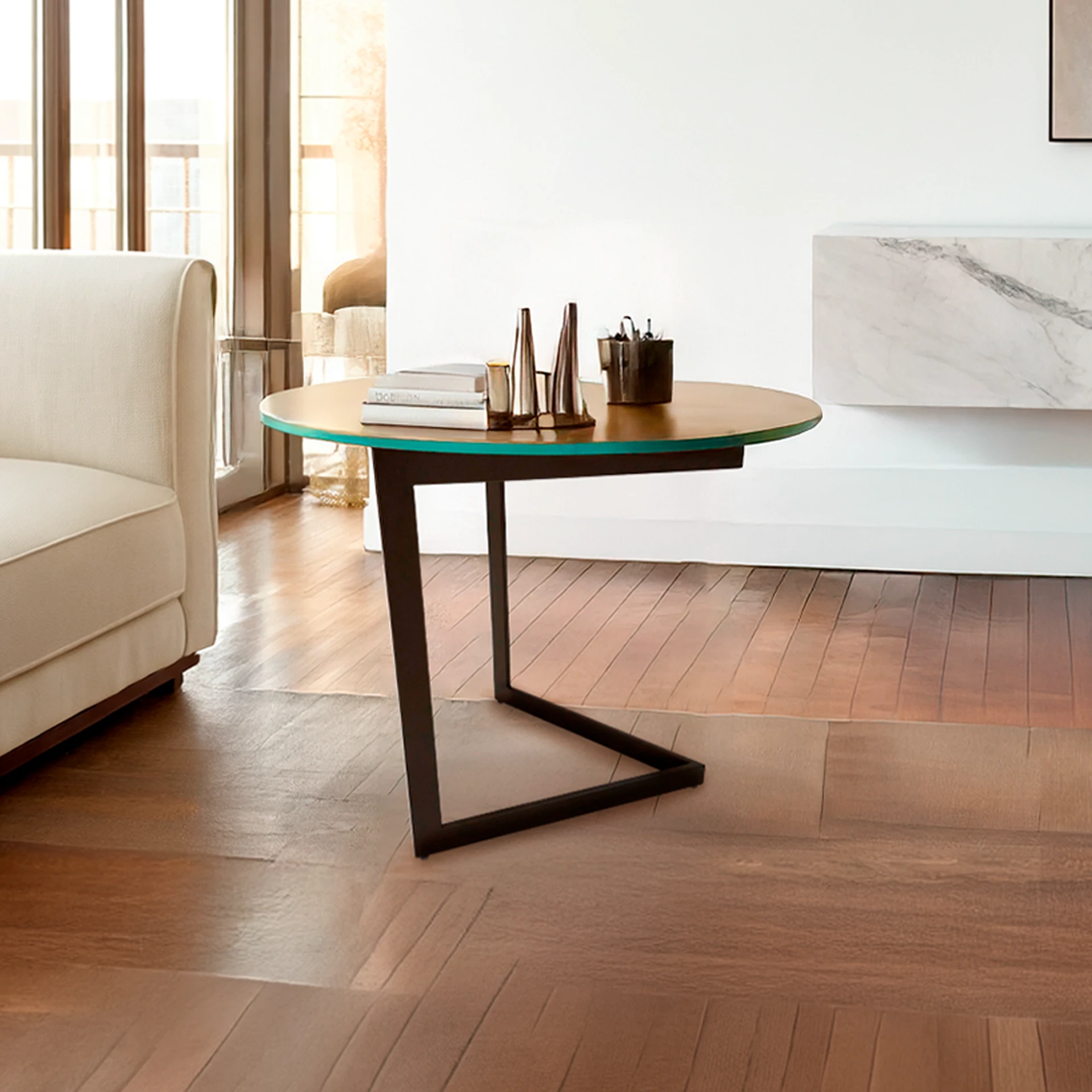 A round wooden side table with a teal edge and black metal base, next to a cream sofa in a brightly lit room with wooden floors.