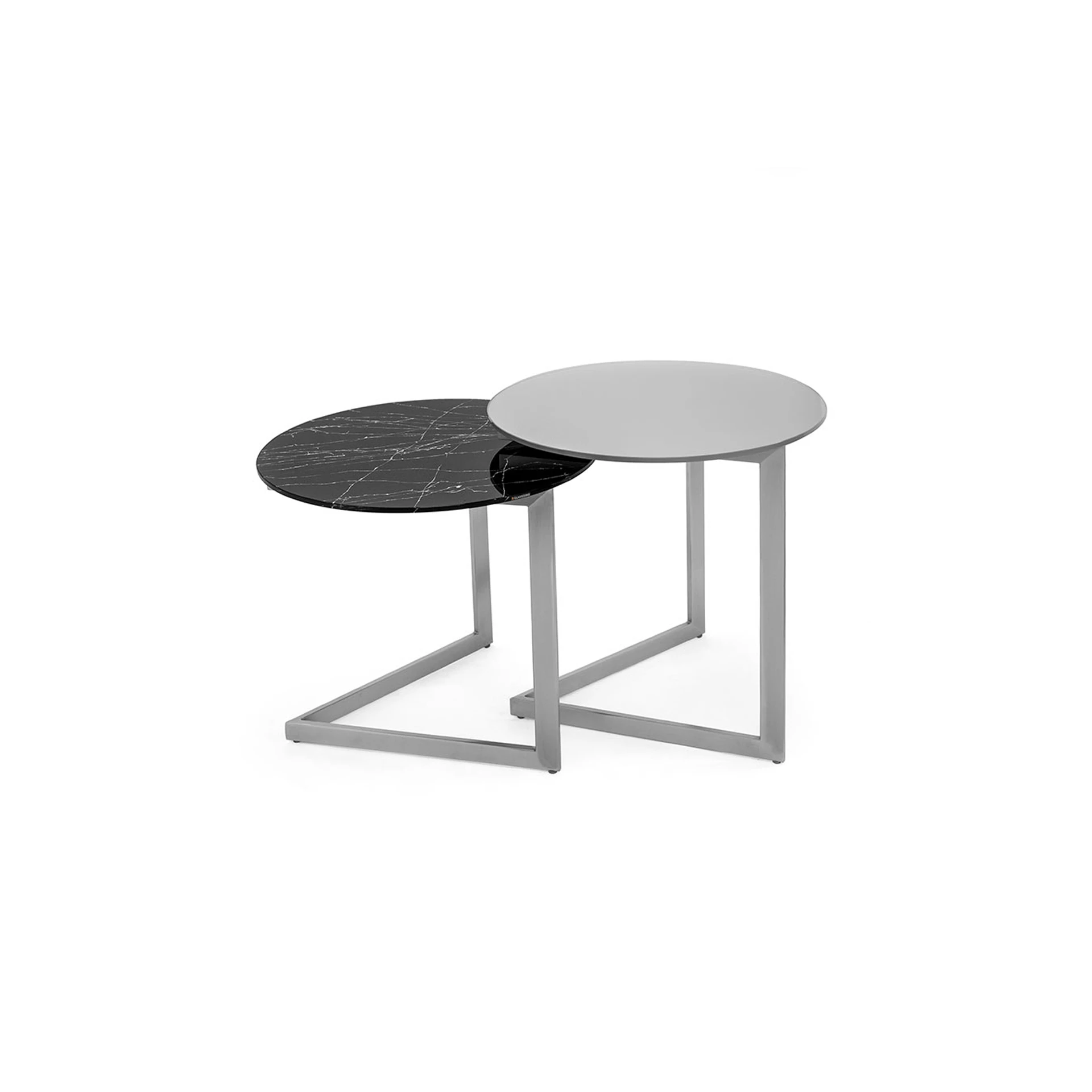 Two round nesting tables with silver metal frames. One table has a black marble-patterned top, and the other has a plain light gray top.