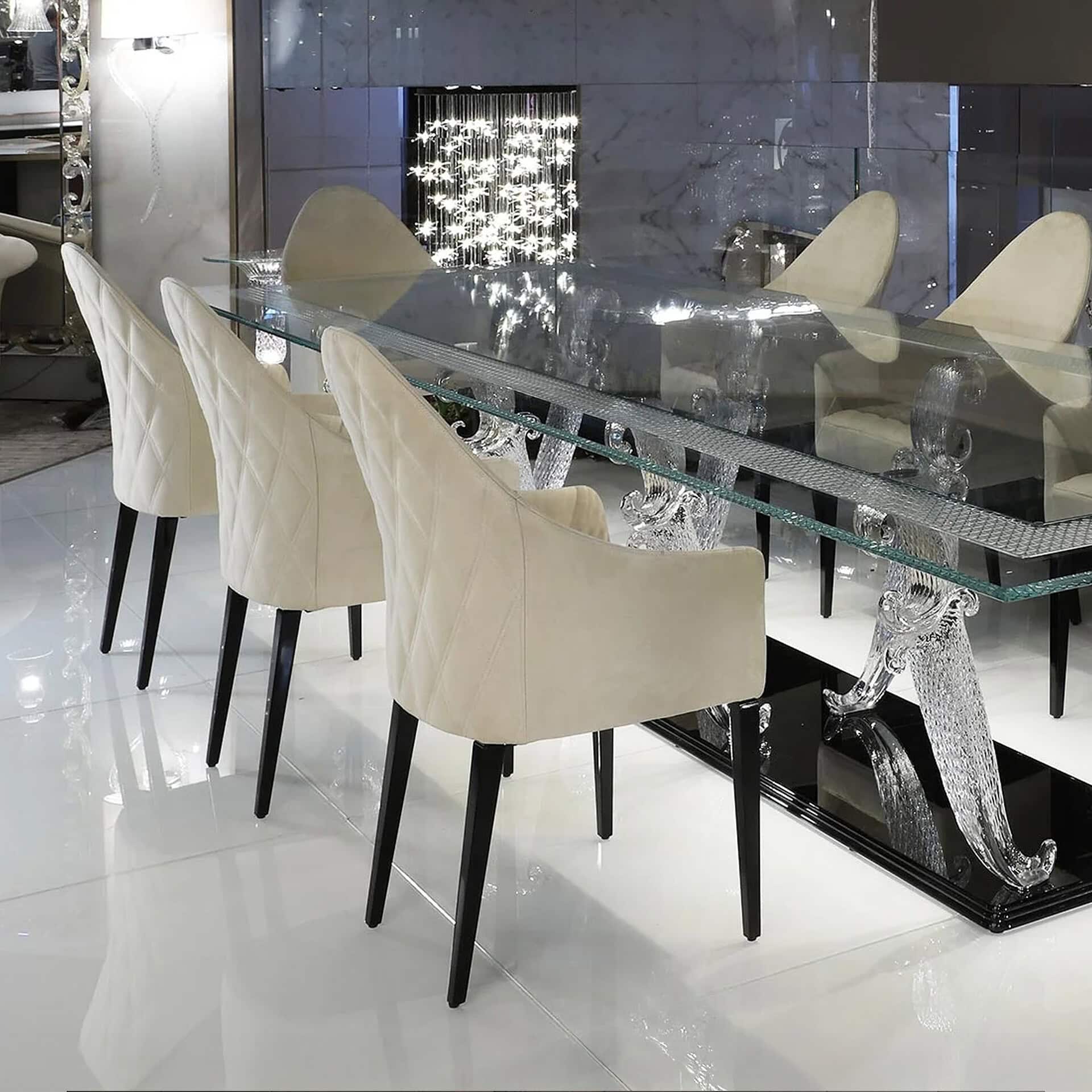 Luxurious glass dining table with cream upholstered chairs in a modern, elegant interior.